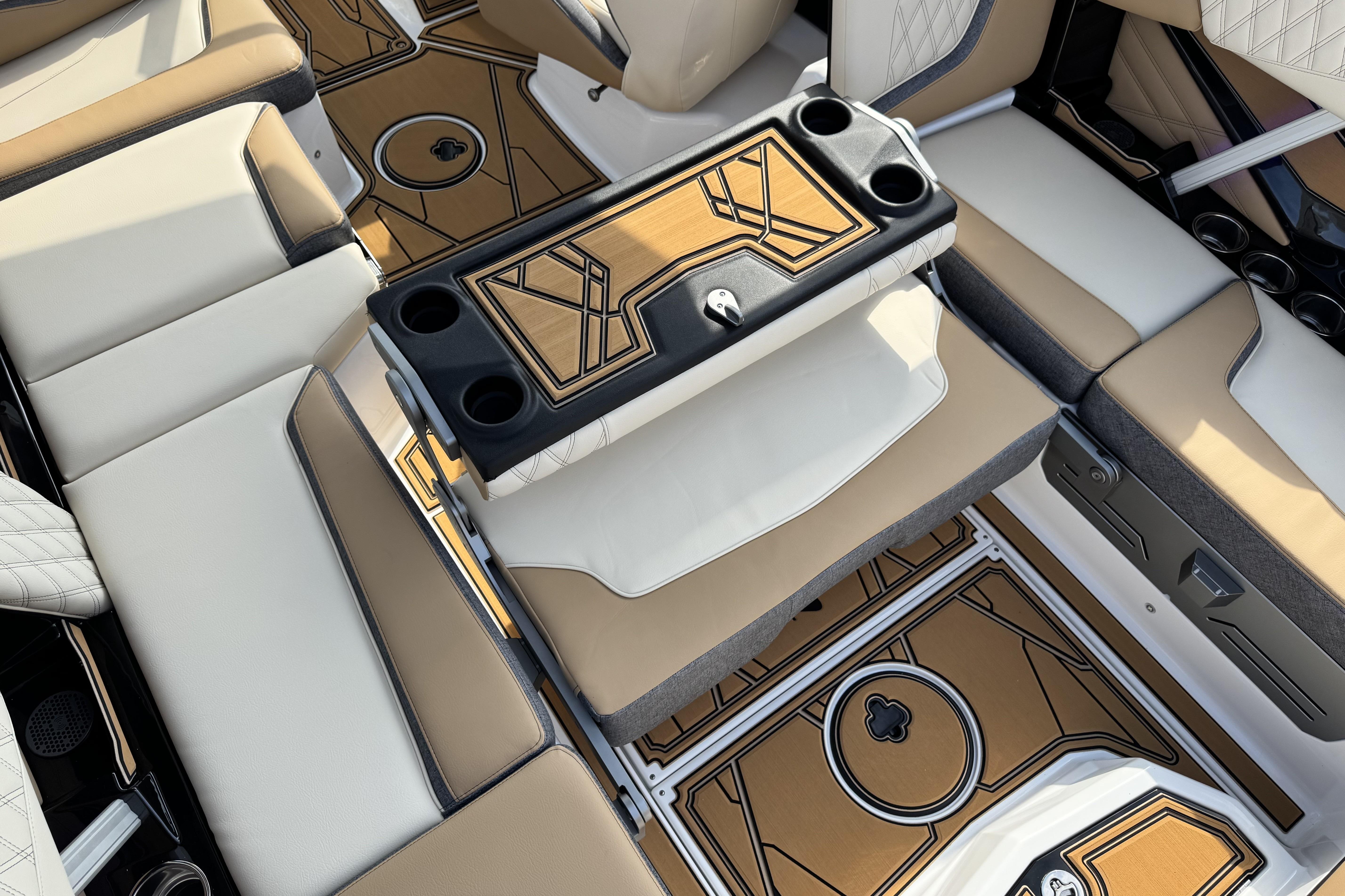 2026 Tigé 24RZX boat interior with tan and white seating, stylish flooring, and cup holders.