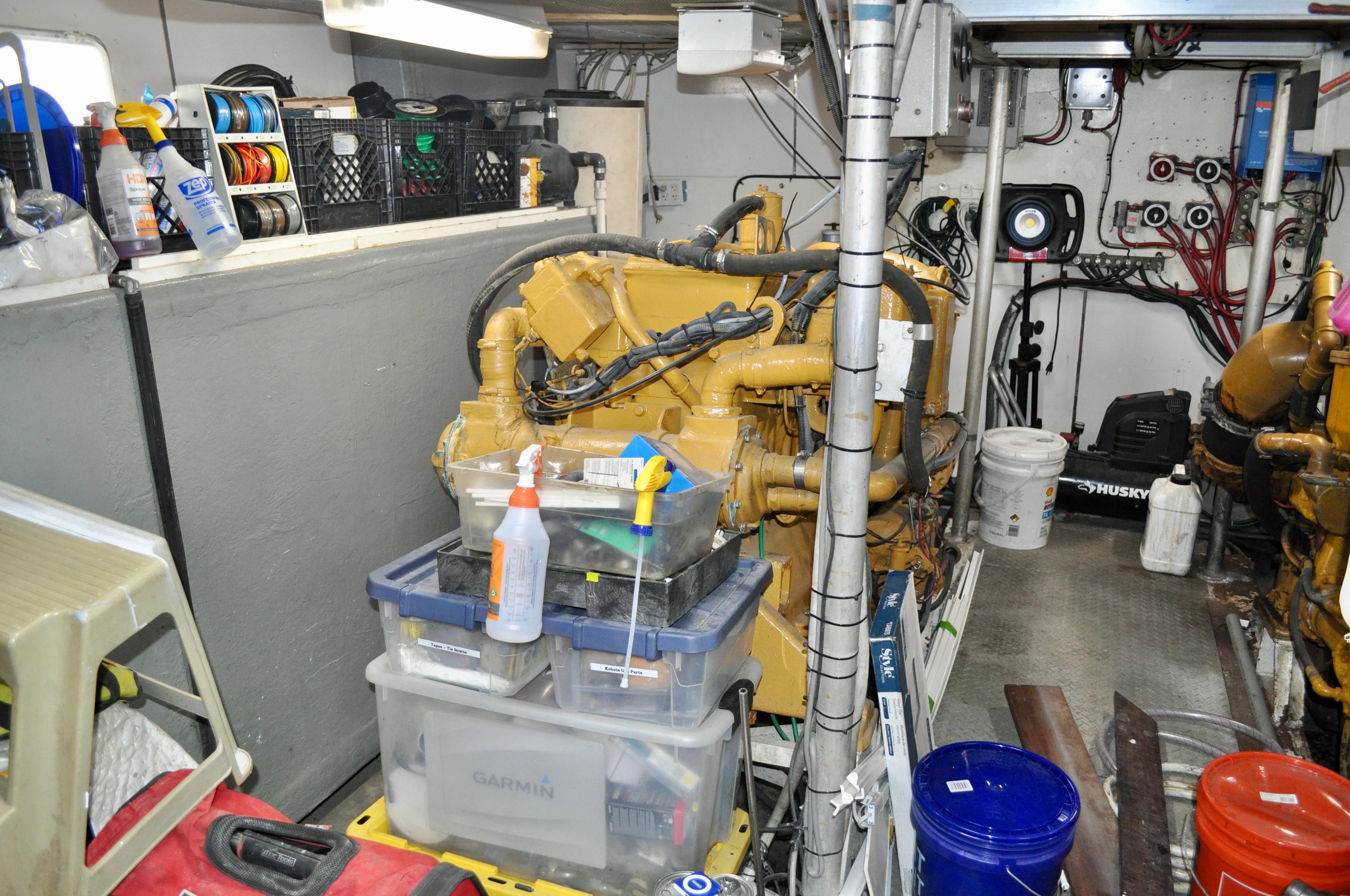 Engine room of 1971 Custom Superior Motor Yacht 64 with organized tools and equipment.