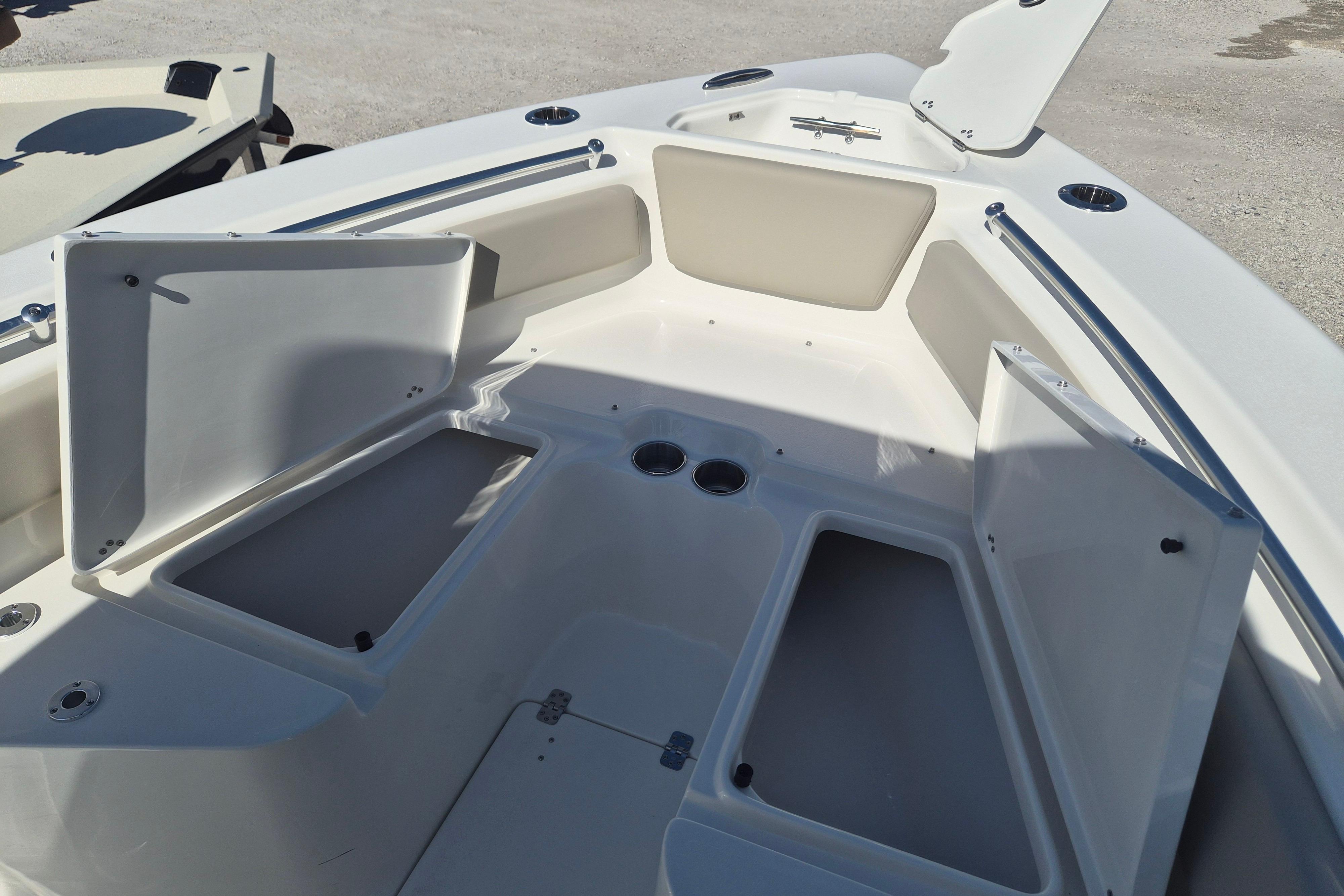 2026 Key West 239 FS boat interior with open storage compartments and cup holders.