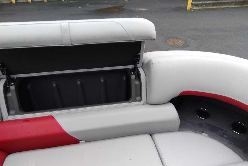 2026 Sun Tracker Party Barge 22 XP3 interior seating with storage compartment open.