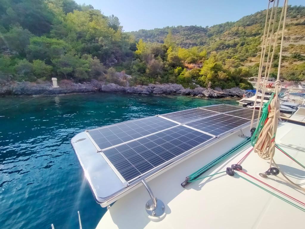 Lagoon 450 catamaran with solar panels, anchored in a scenic bay, 2018 model.