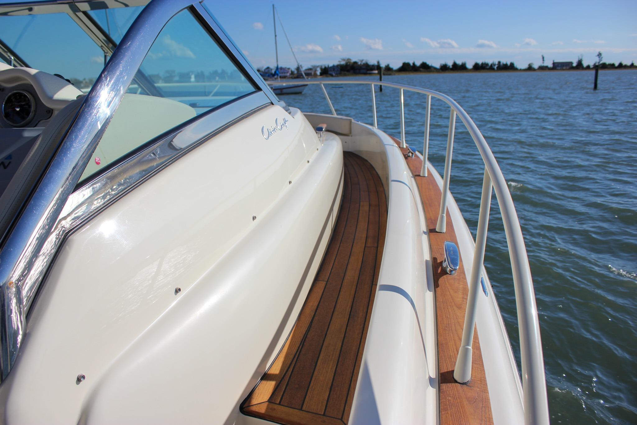 2017 Chris-Craft Launch 38 boat with wooden deck, cruising on a sunny day.