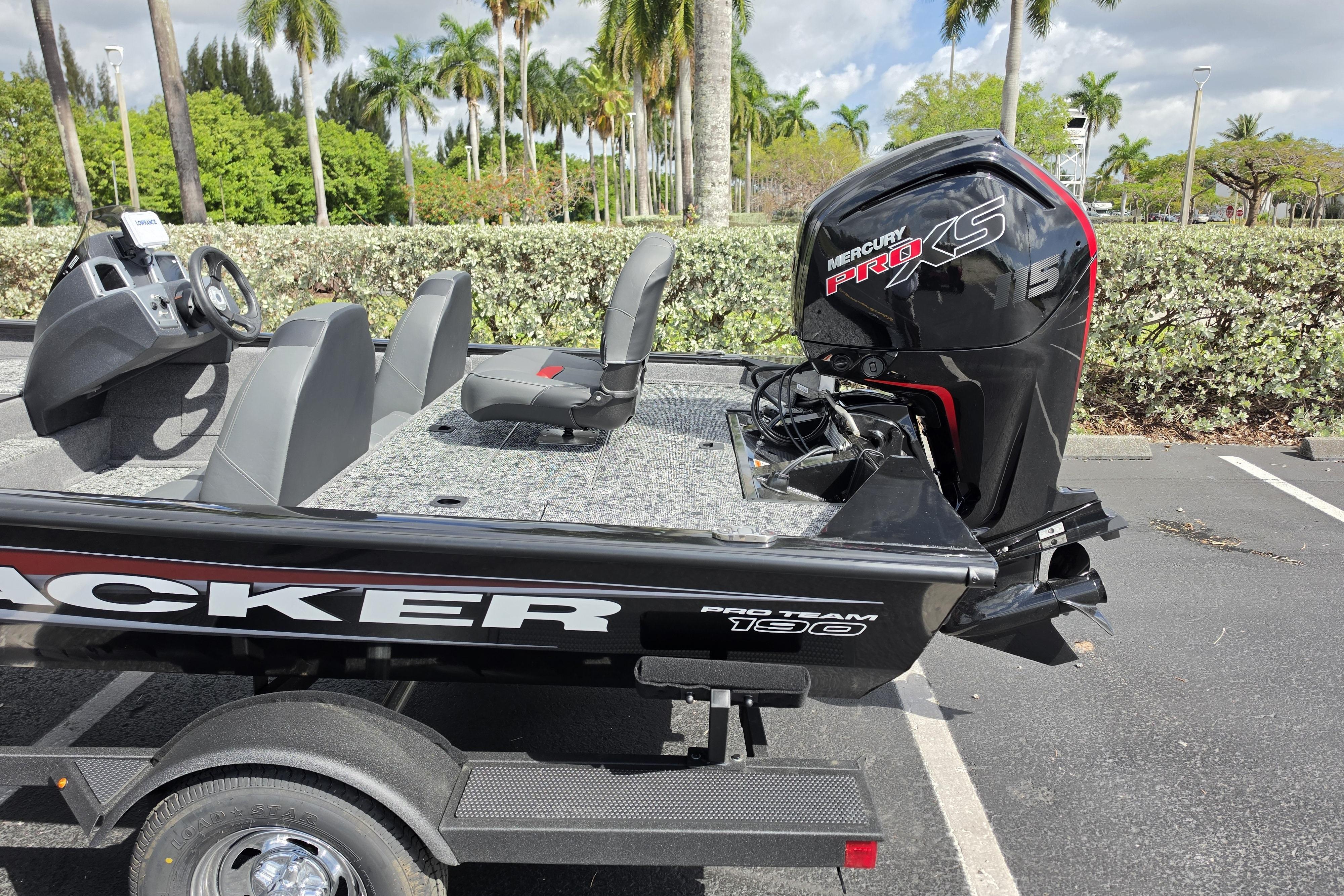 2026 Tracker Pro Team 190 boat with Mercury Pro XS engine in a parking lot.
