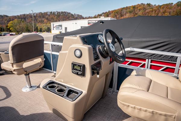 2025 Sun Tracker BASS BUGGY 18 pontoon boat interior with beige seating and steering console.