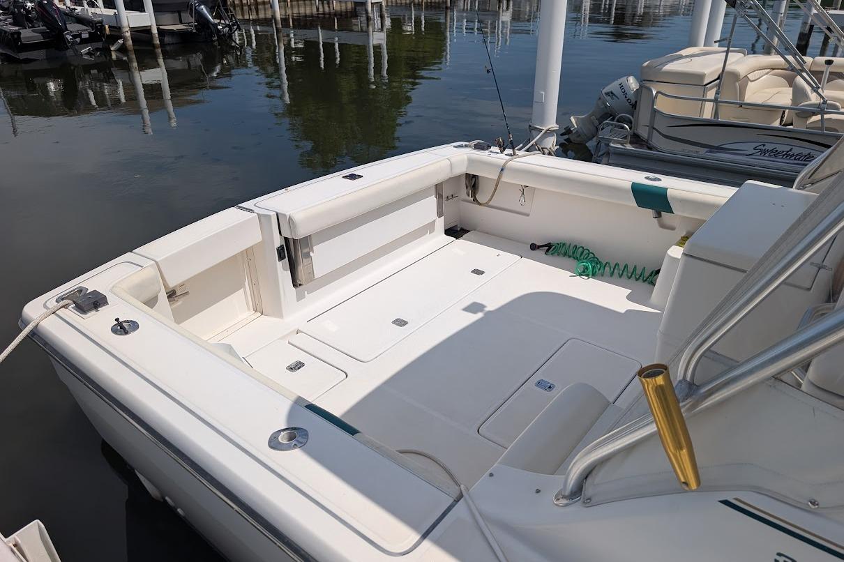 2000 Pursuit 3400 Express boat deck, featuring spacious seating and fishing rod holders.