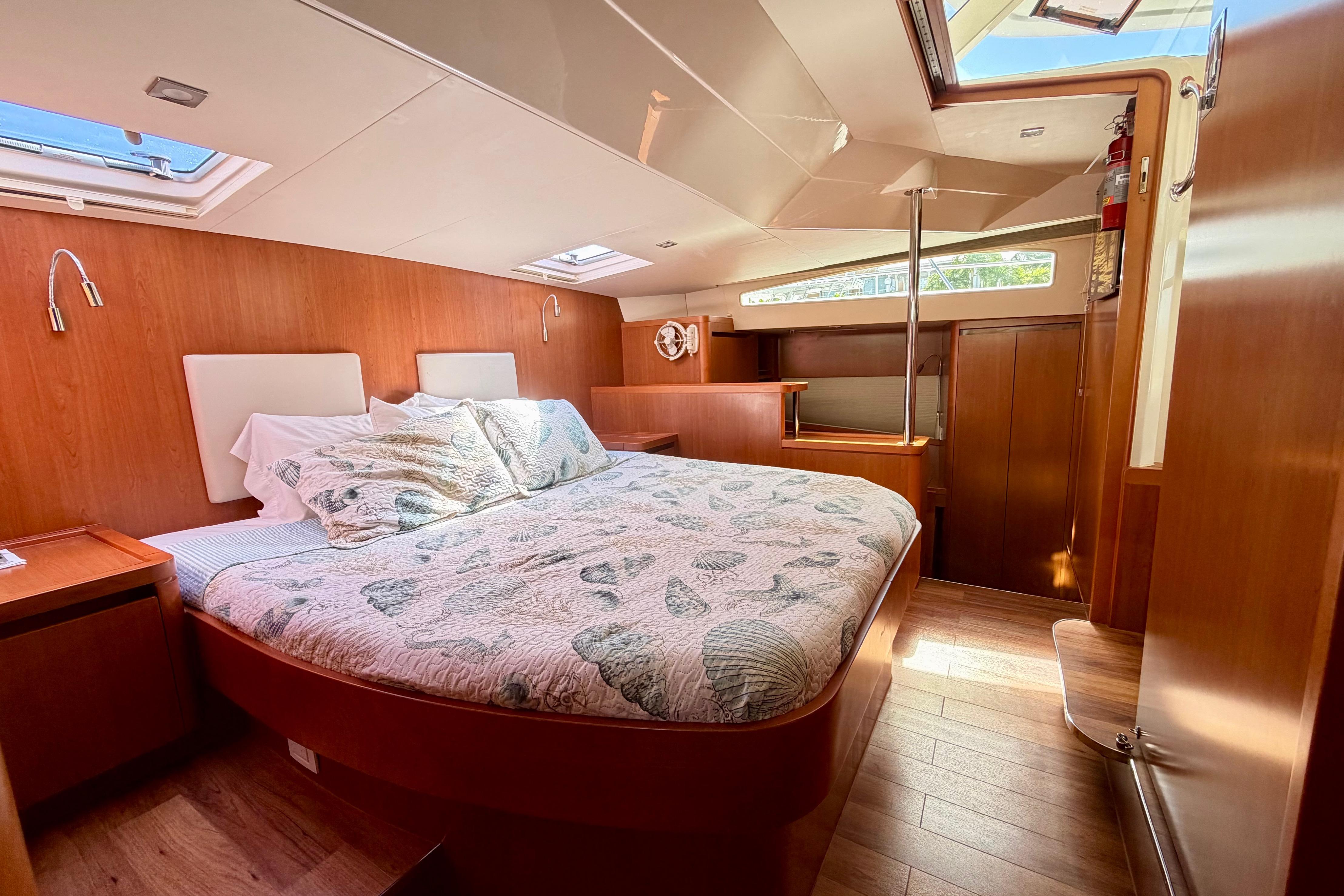 Luxurious 2017 Aquila 44 Yacht bedroom with wood paneling and skylights.