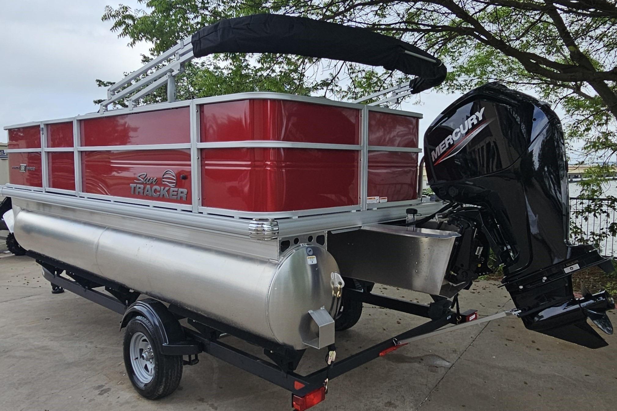 2026 Sun Tracker Party Barge 18 DLX pontoon boat with Mercury outboard motor.