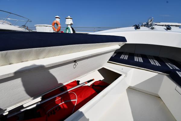 2021 Eastern 248 Center Console boat with open storage compartment and life jackets.