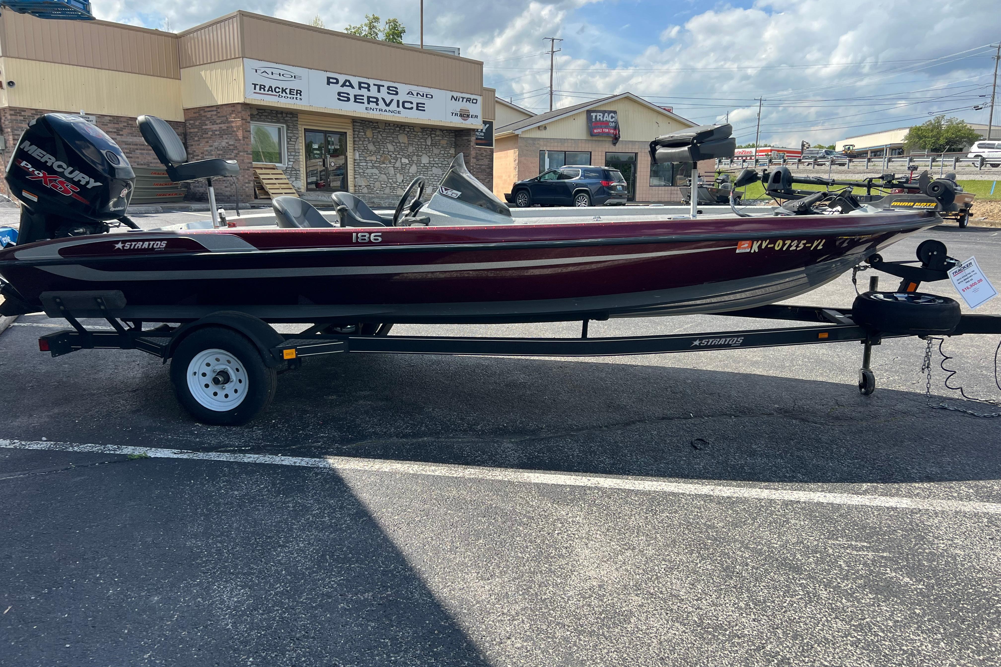 2015 Stratos 186 VLO boat on trailer, parked outside service center.