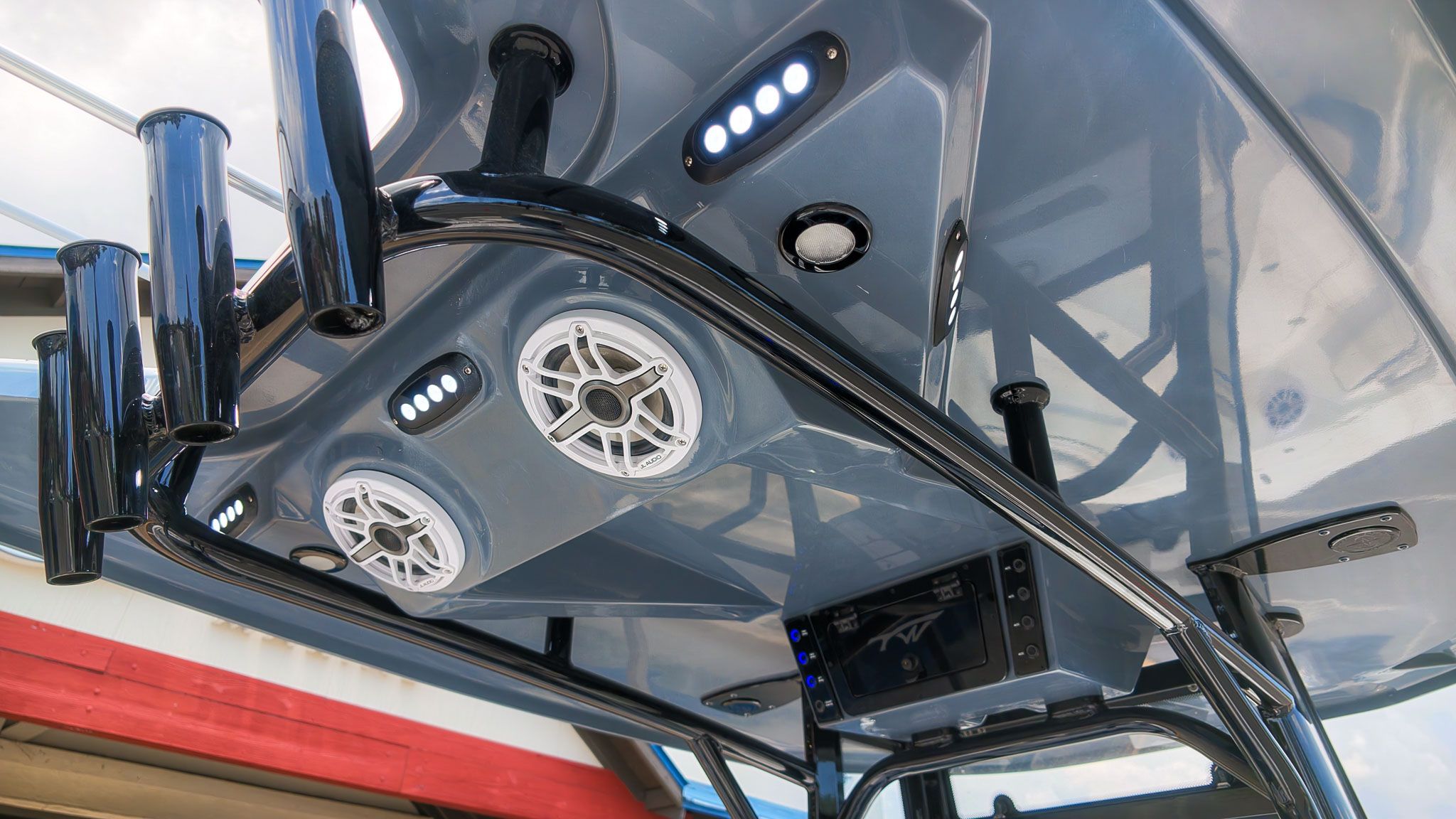 The image shows a boat's roof with speakers and LED lights.