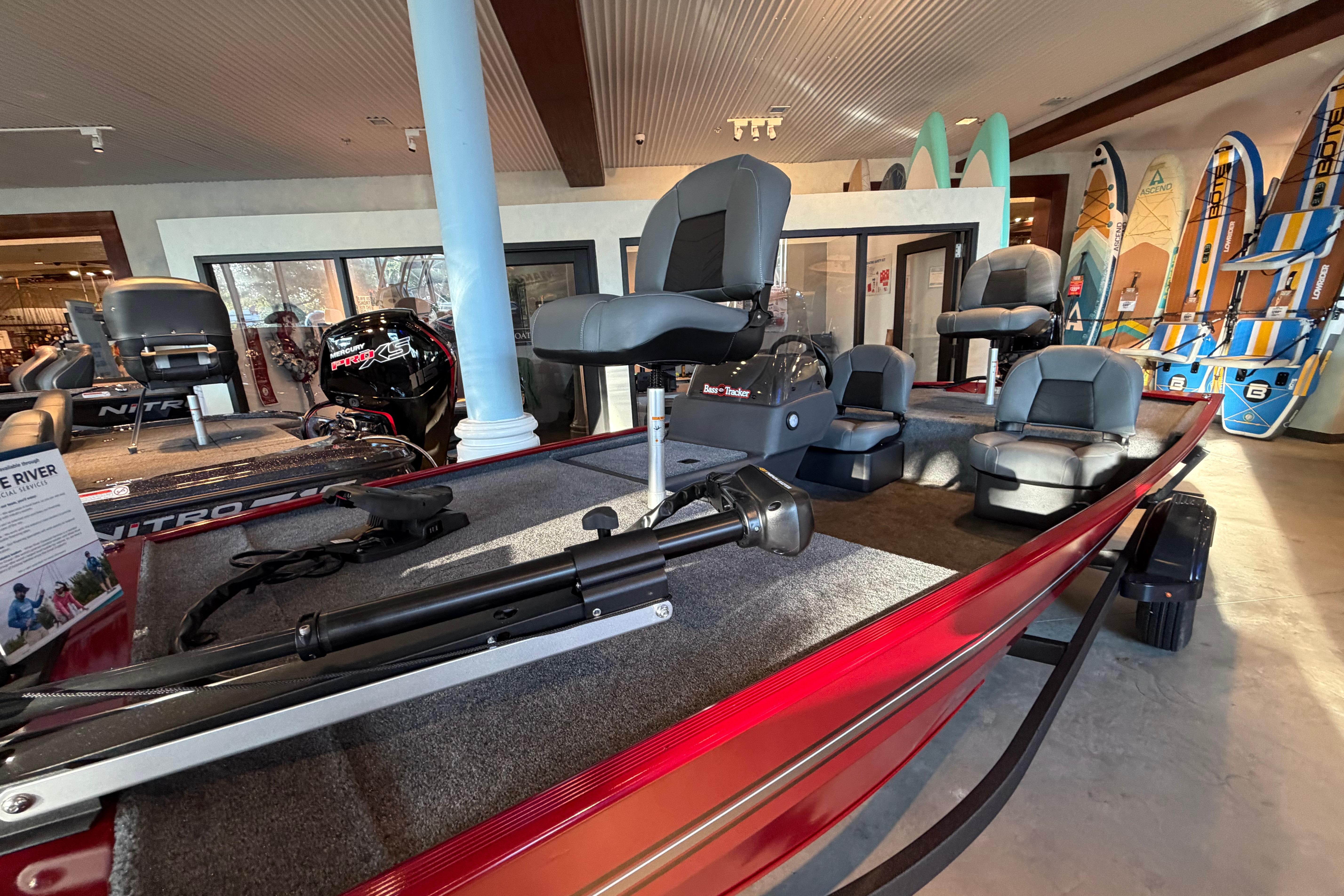 2026 Tracker Bass Tracker Classic XL boat displayed in a showroom with seating and equipment.