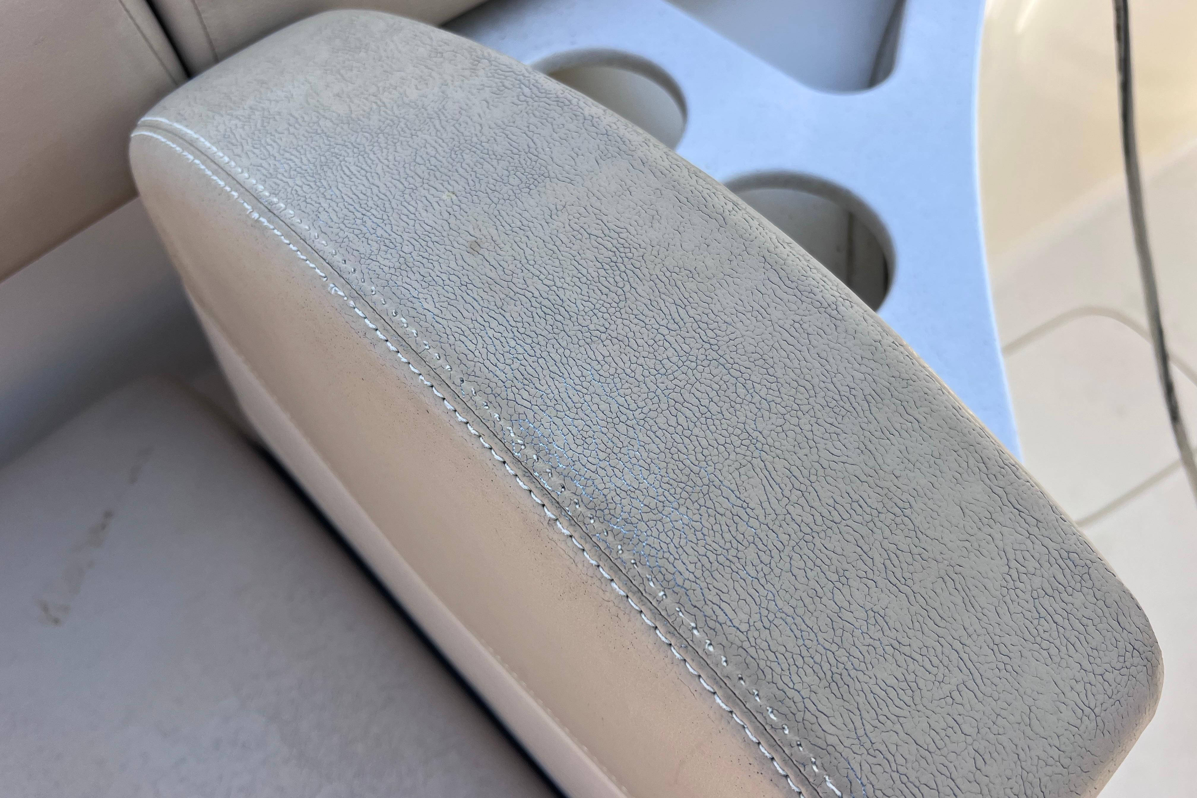 Close-up of 2019 Scout 275 LXF boat seat with textured upholstery and cup holders.