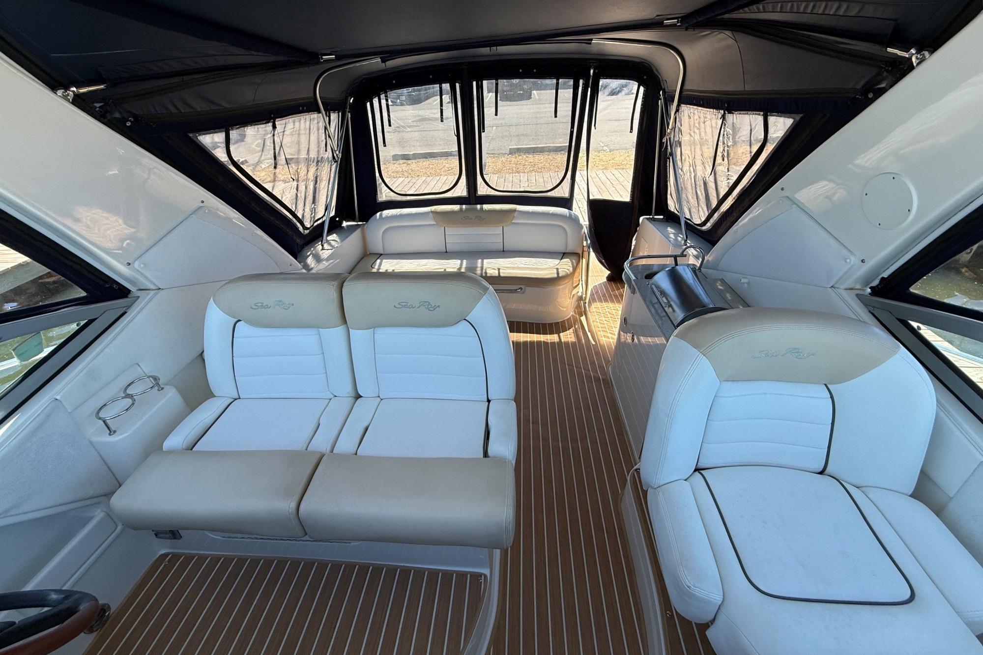 Interior of 2008 Sea Ray Sundancer 330 yacht with white seating and wood flooring.