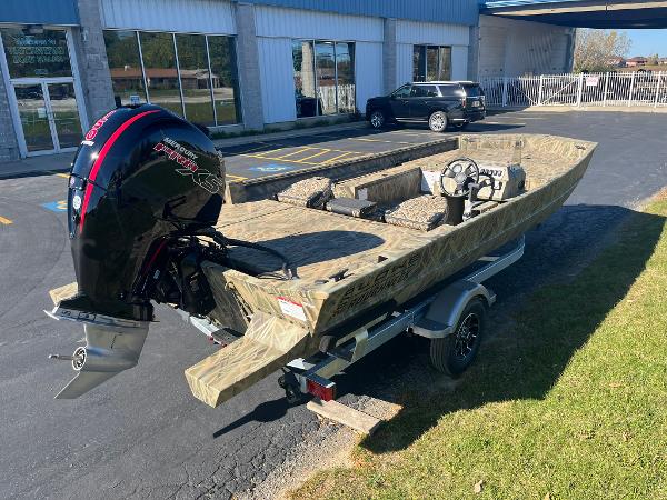 2025 Lowe Roughneck 2070 SC boat on trailer, parked outside dealership.