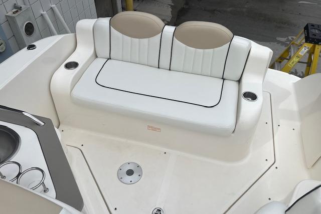 2008 Sea Ray 240 Sundancer boat interior with white seating and cup holders.