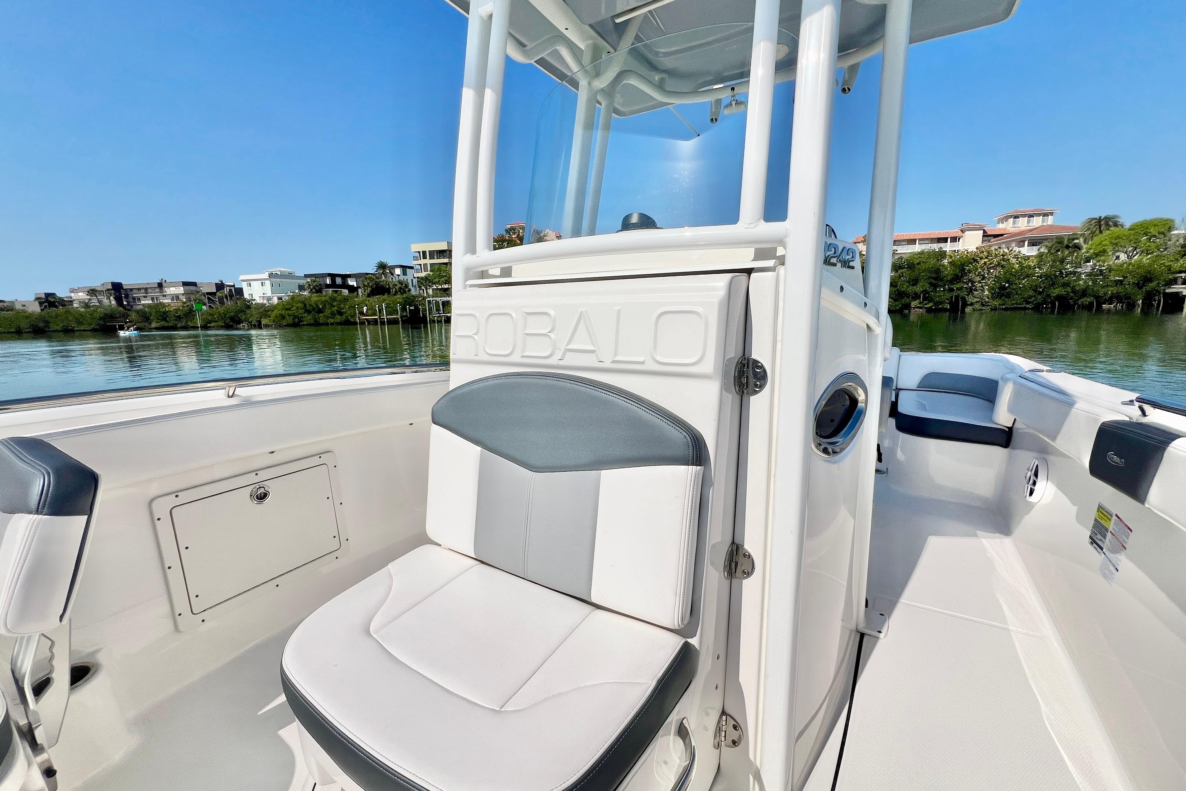 2021 Robalo R242 Explorer boat interior with seating, on a sunny day by the water.