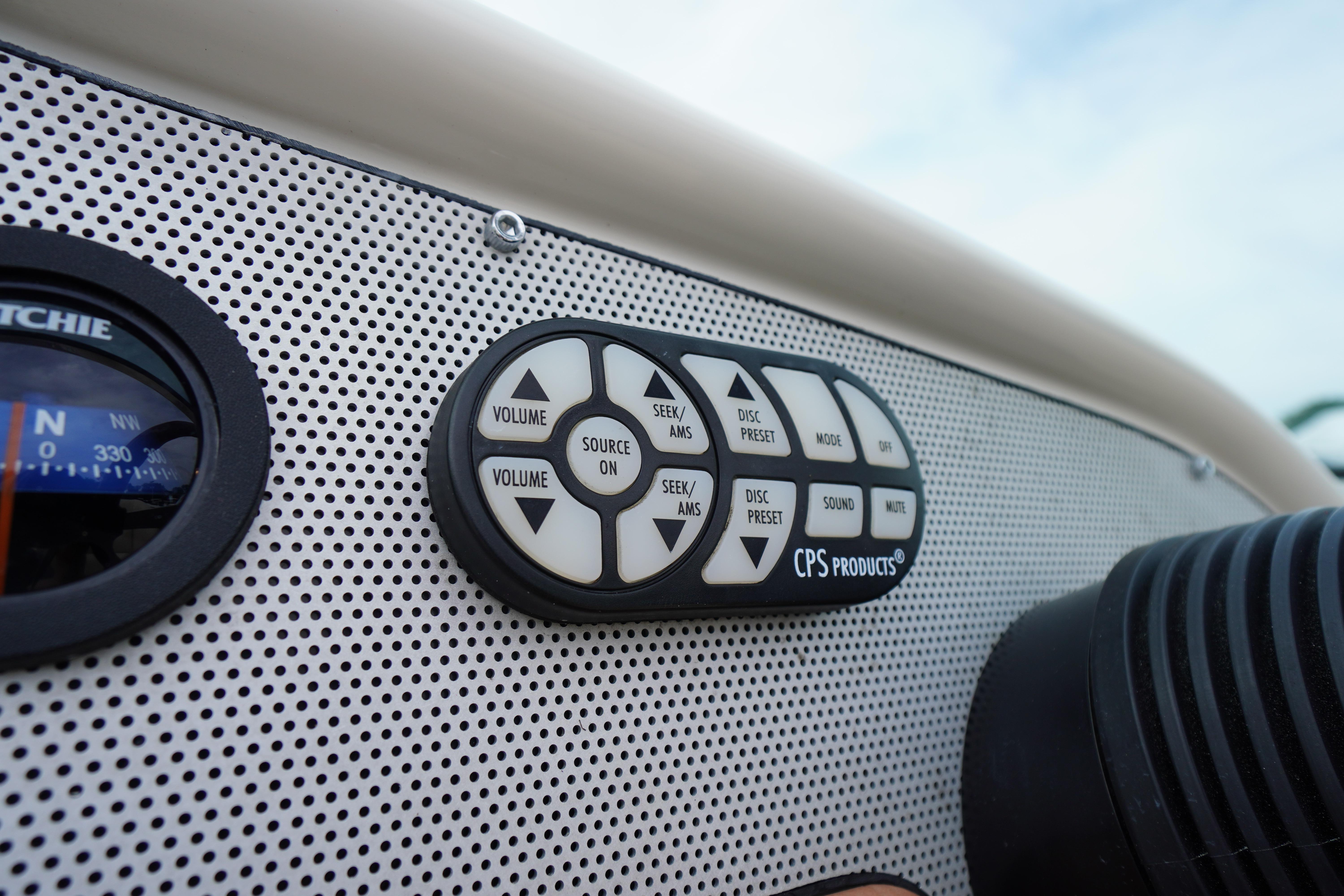 Dashboard controls of a 2005 Chris Craft Speedster Heritage boat, featuring audio system buttons.