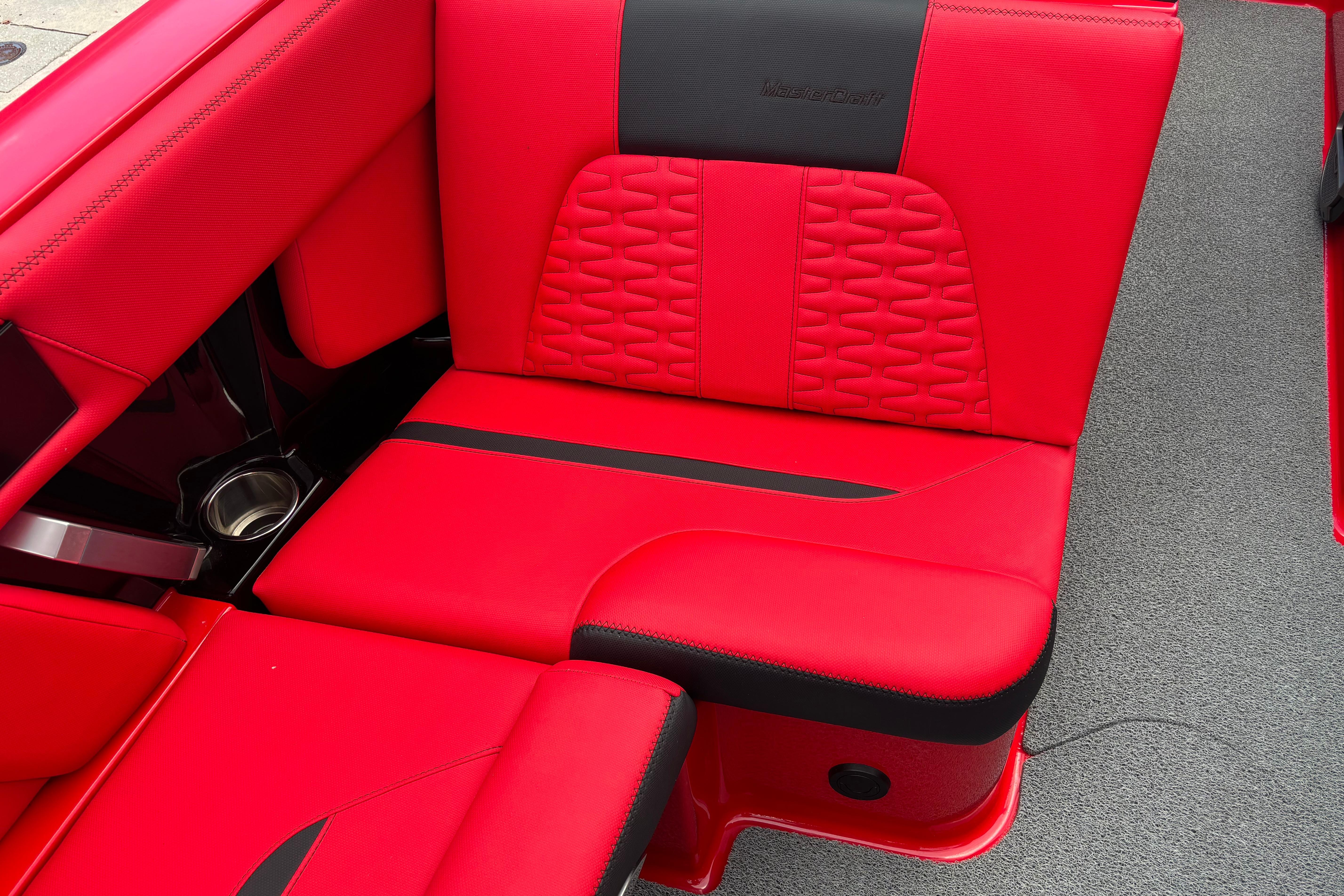 Red and black interior seating of 2020 MasterCraft X24 boat.