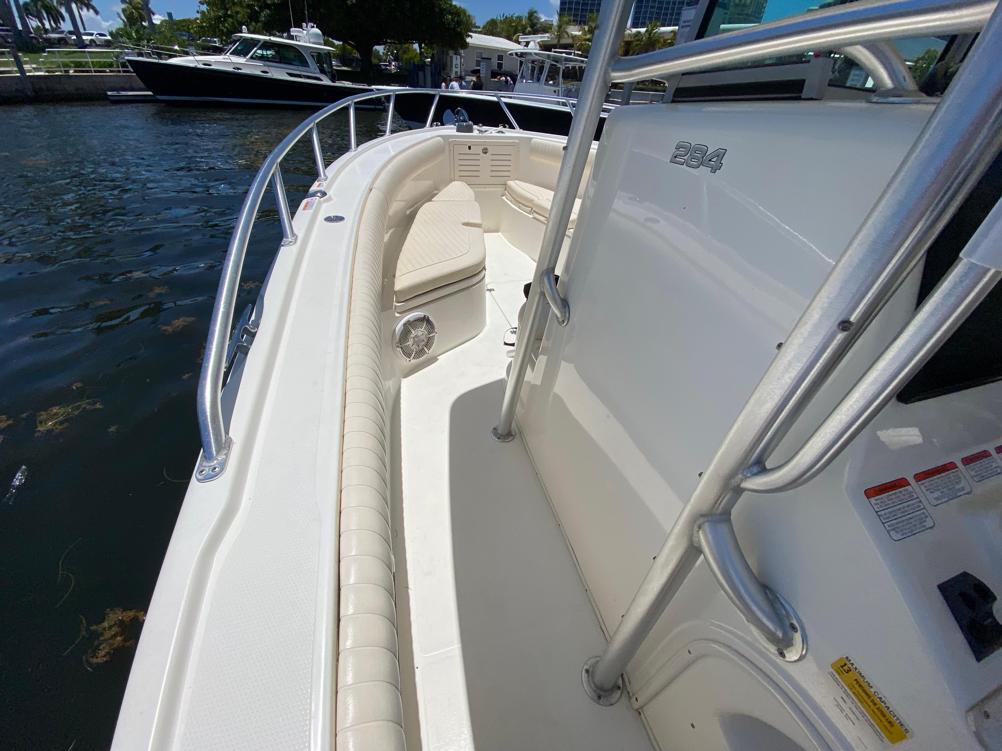 2014 Mako 284 CC boat docked, showcasing sleek design and spacious deck.