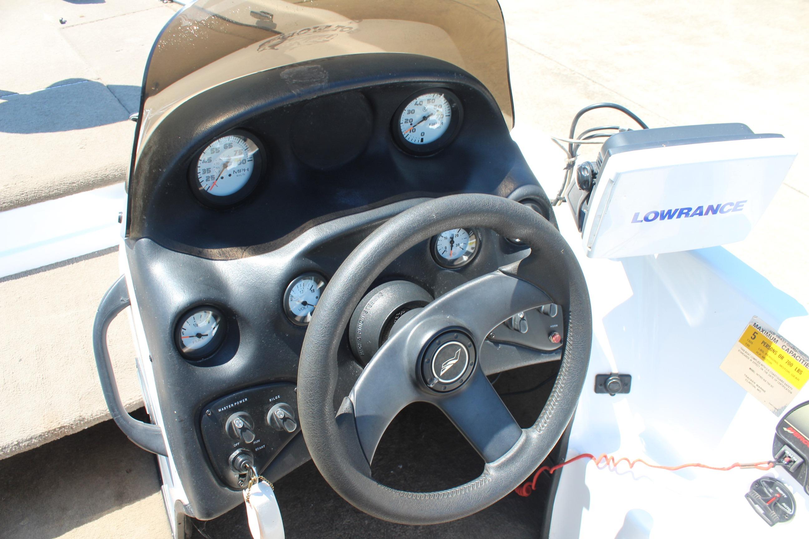 Dashboard of a 2003 Nitro NX 750 SC boat with steering wheel and Lowrance display.