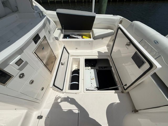 The image shows the interior of a Regal 33 SAV boat with open storage compartments.