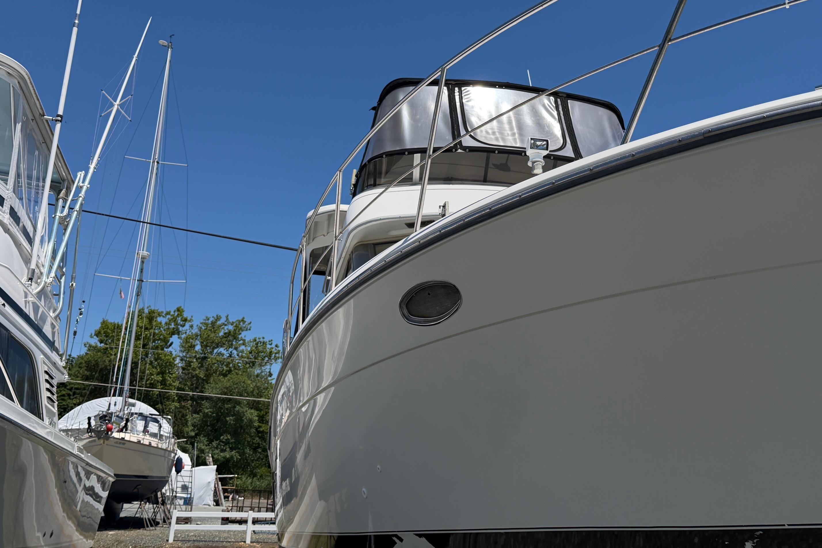 1995 Carver 356 Aft Cabin Motor Yacht docked, showcasing sleek design and spacious cabin.