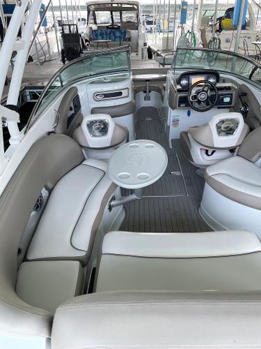 2019 Crownline E255 boat interior with seating, table, and steering console.
