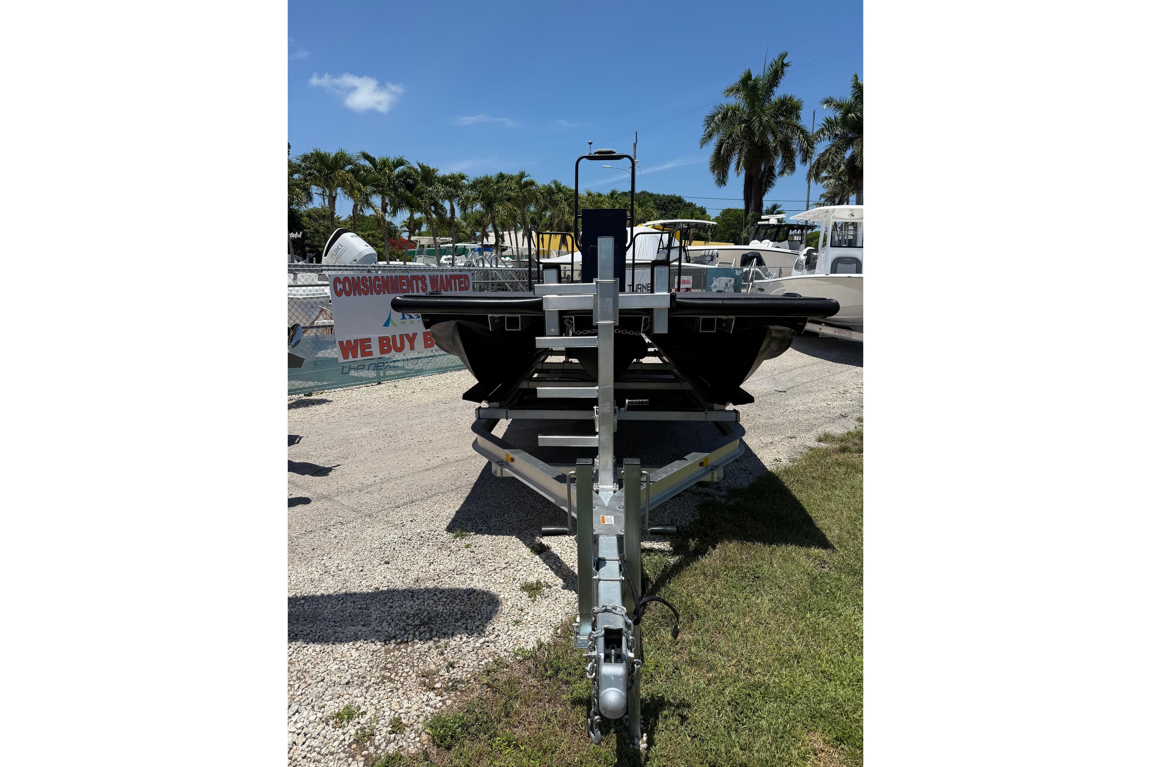 Trailer with Tough 20 boat, 2026 model, parked outdoors under clear blue sky.