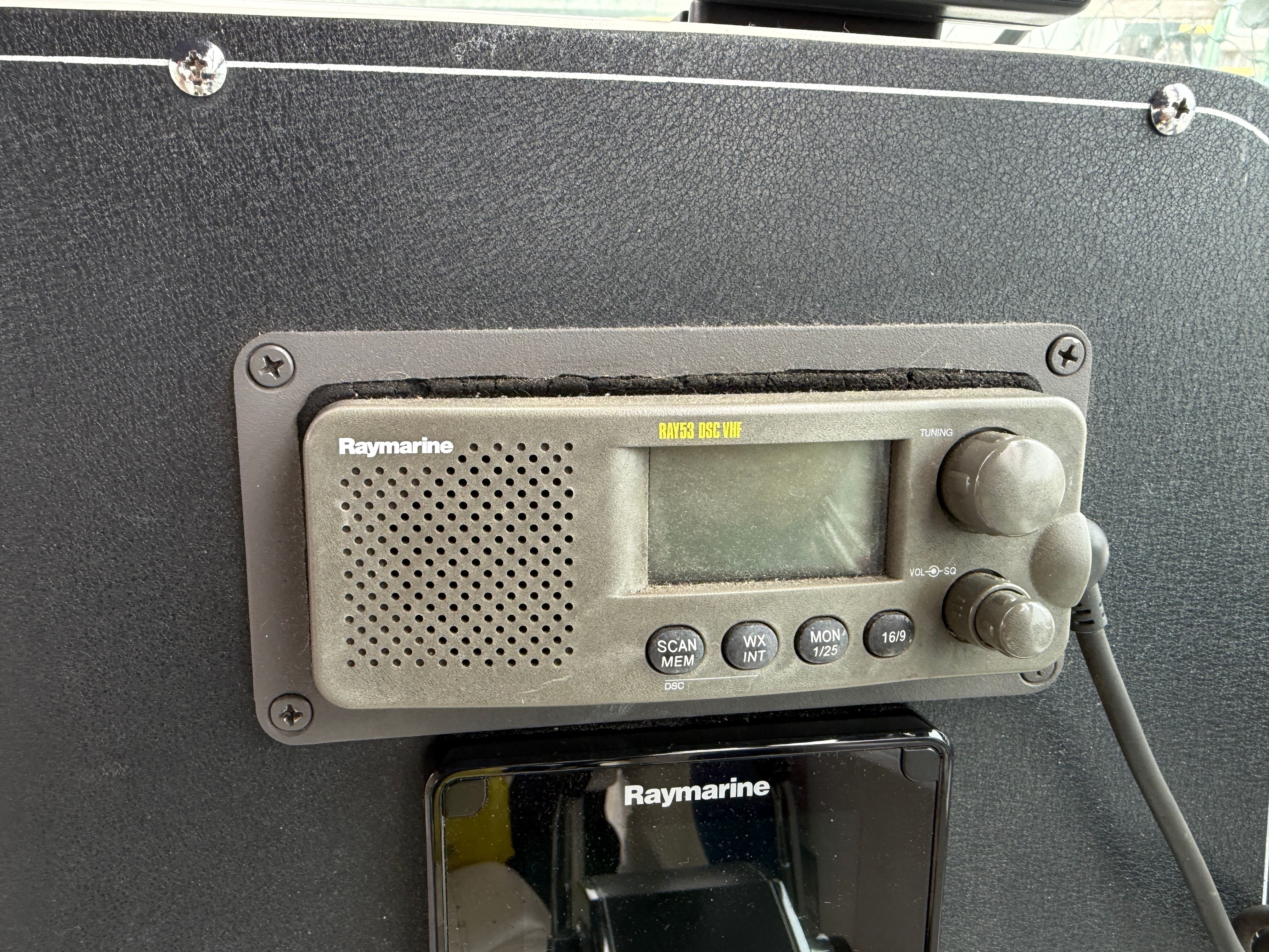 A Raymarine radio is mounted on a boat's dashboard.