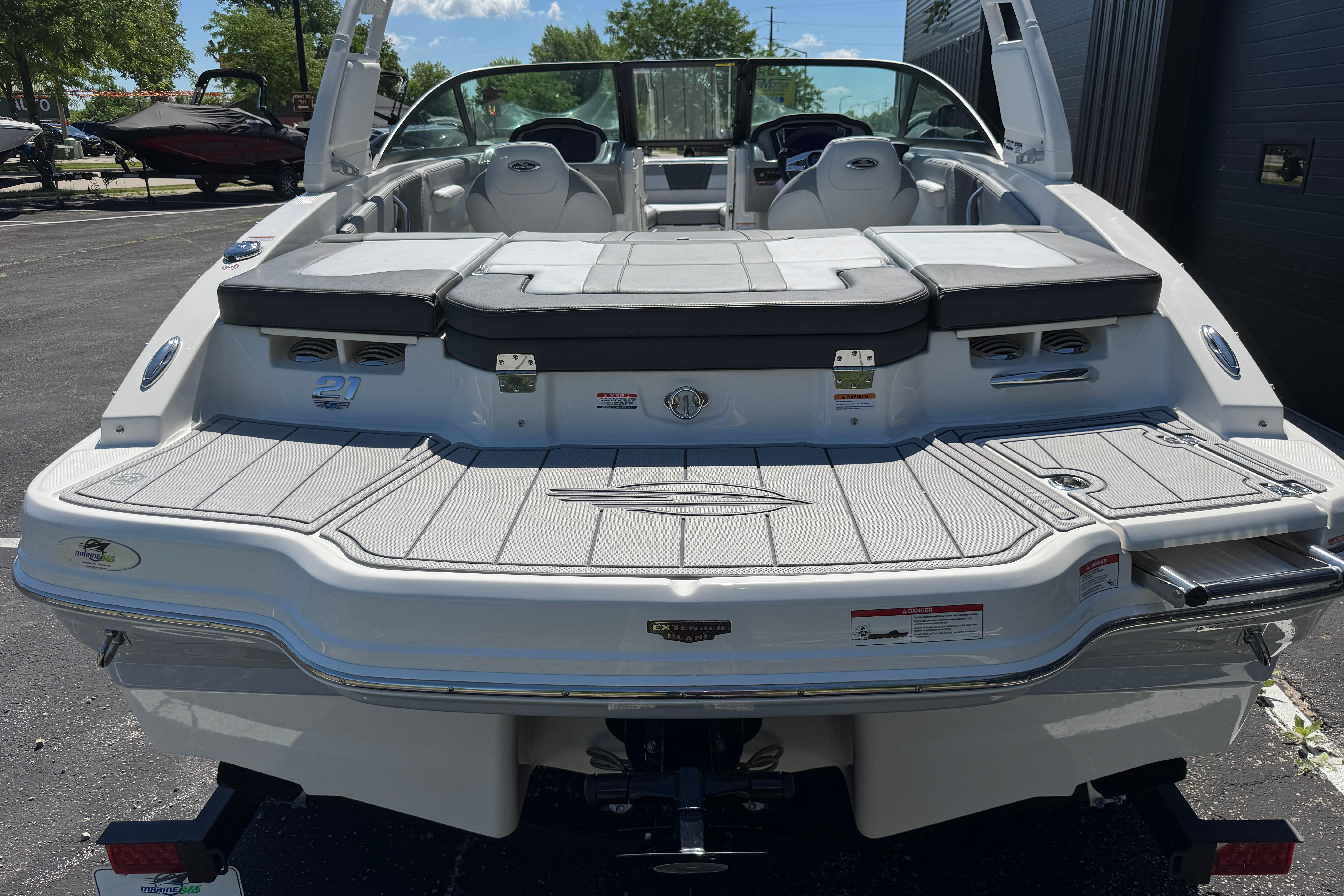 2026 Chaparral 21 SSi boat, rear view, showcasing spacious deck and seating.