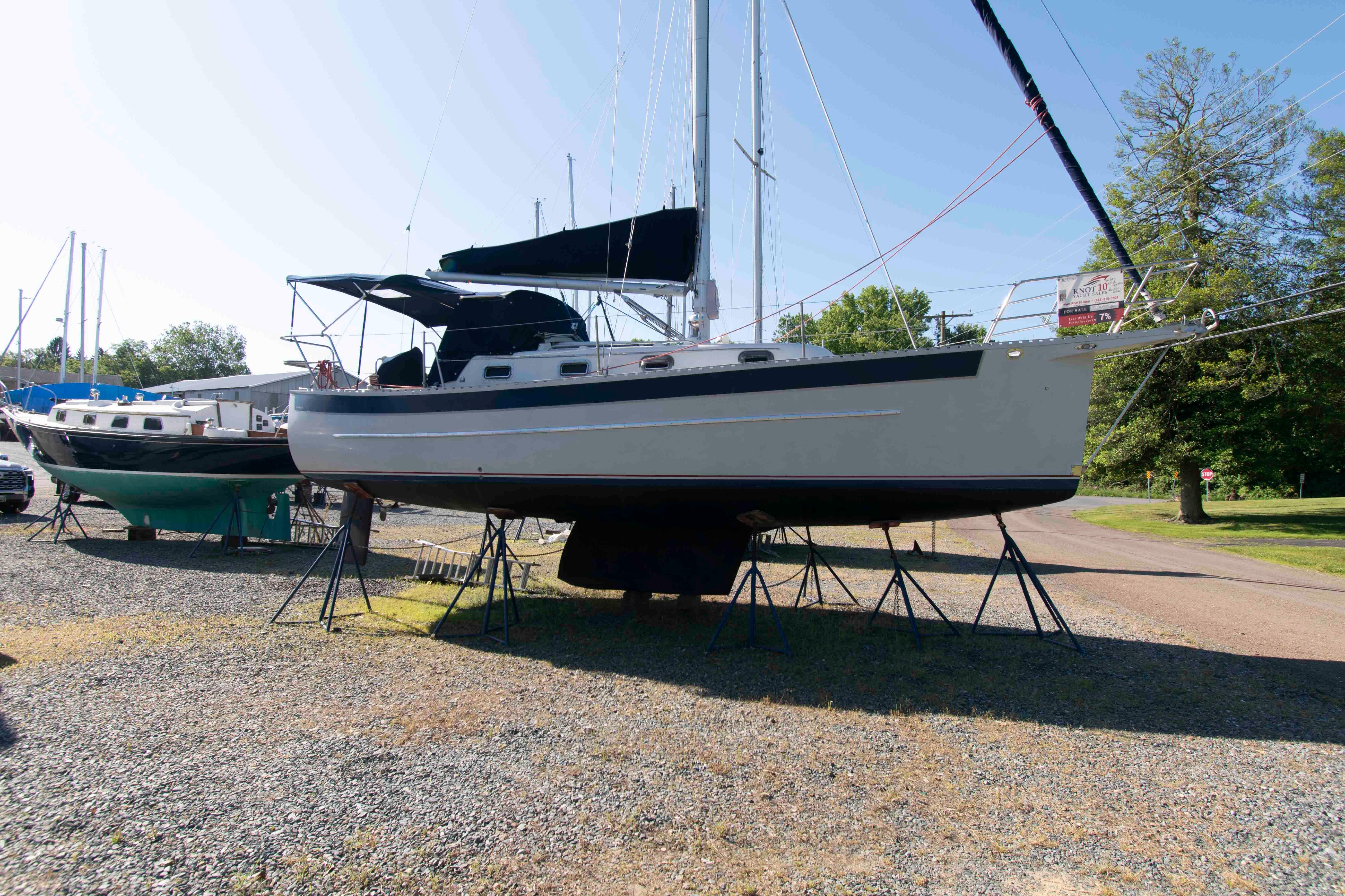 1999 Seaward Eagle 32 sailboat on stands in a boatyard, sunny day.