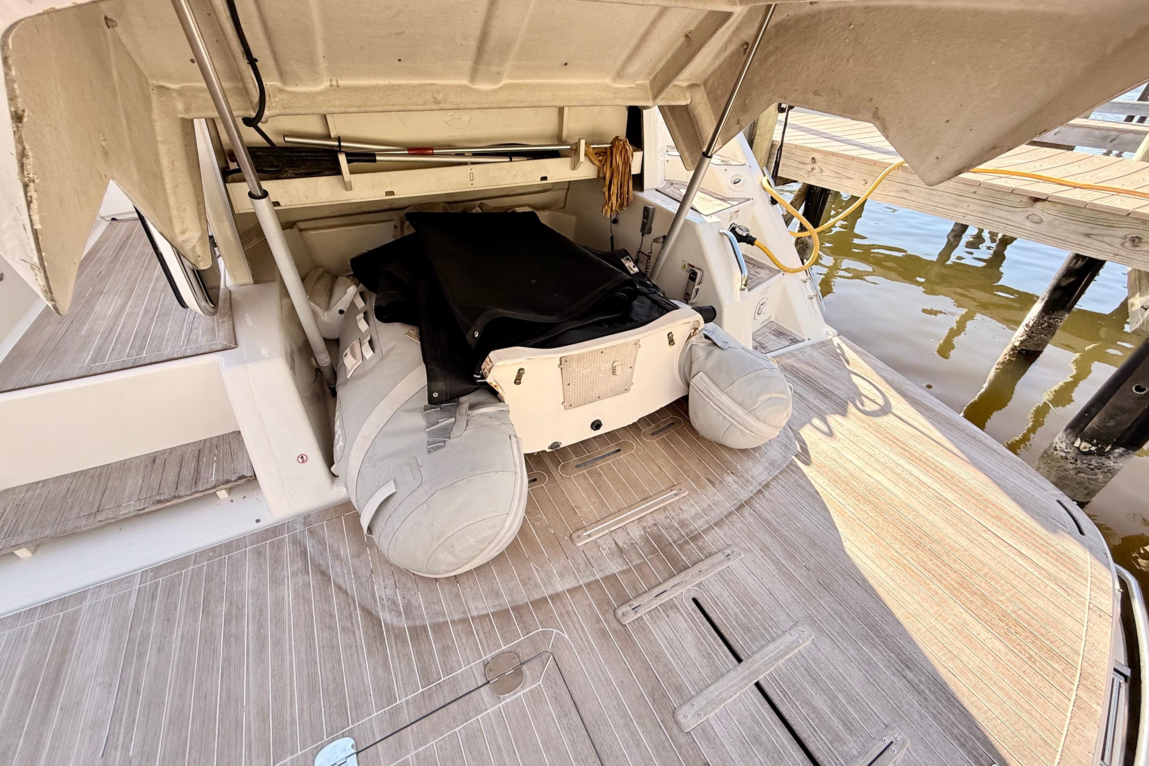 2016 Cranchi M44 HT yacht with open storage compartment and inflatable boat.