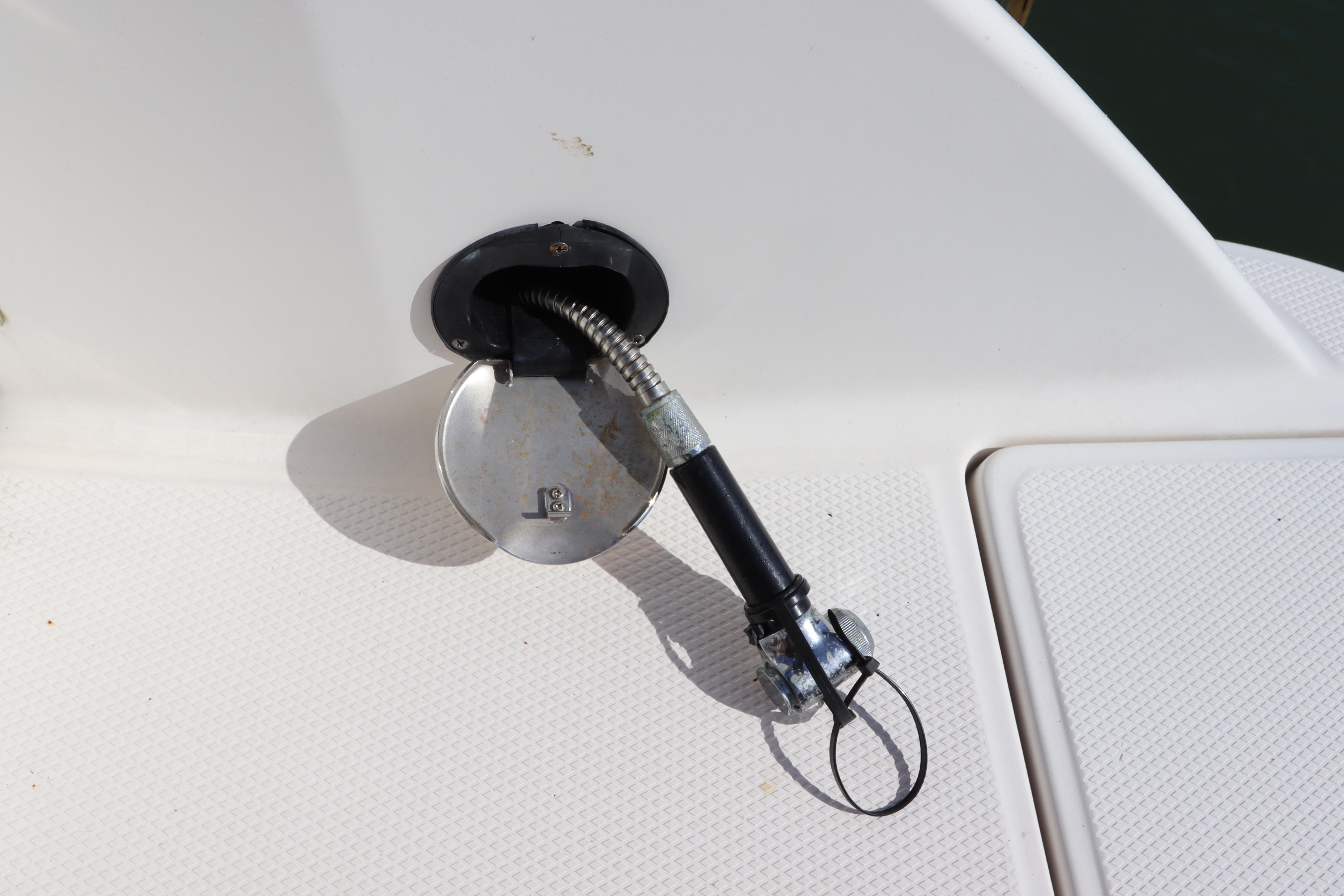 Fuel cap and hose on 2019 Robalo R242 Center Console boat deck.