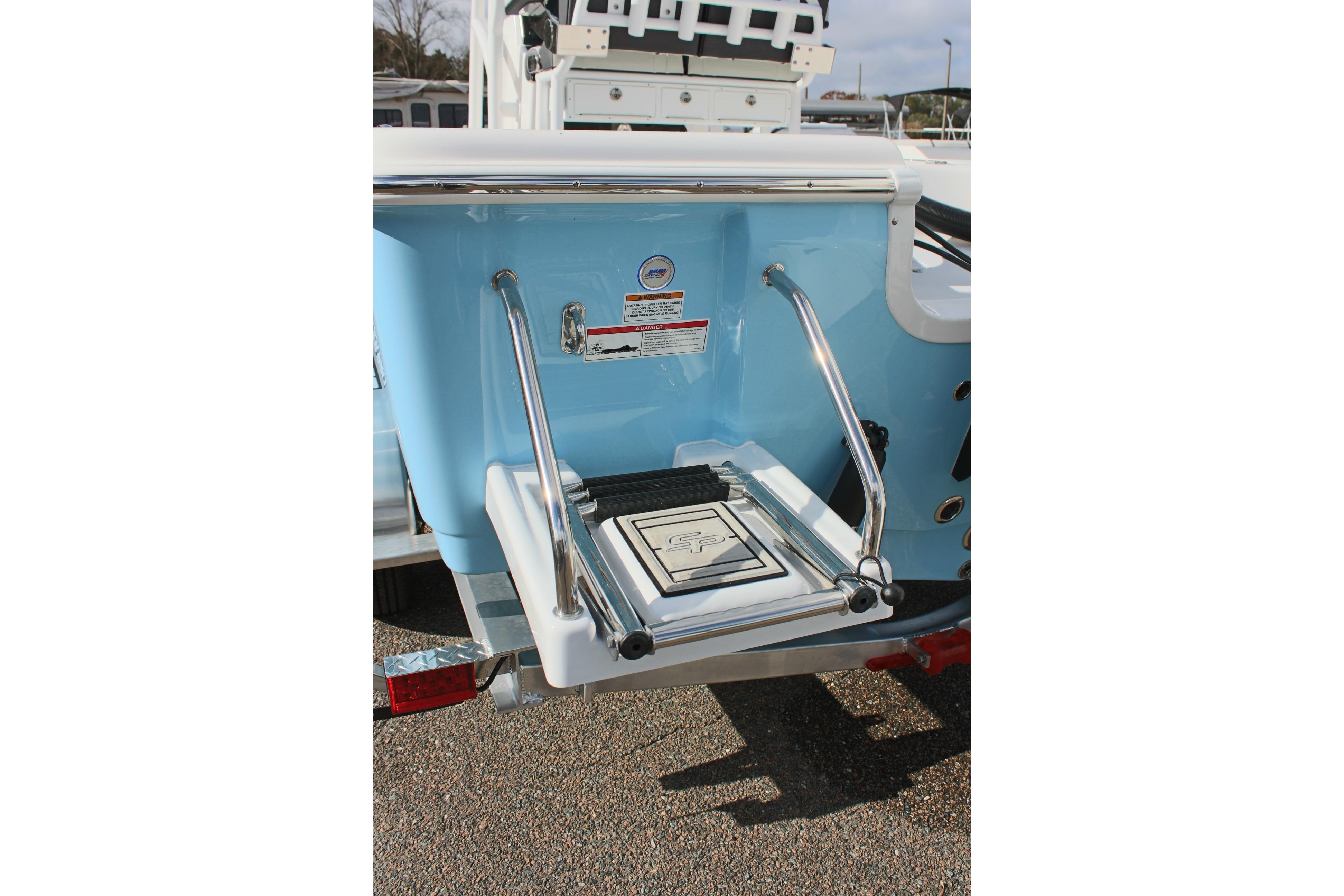 2025 Sea Pro 230 Bay boat with a foldable swim ladder and blue hull.