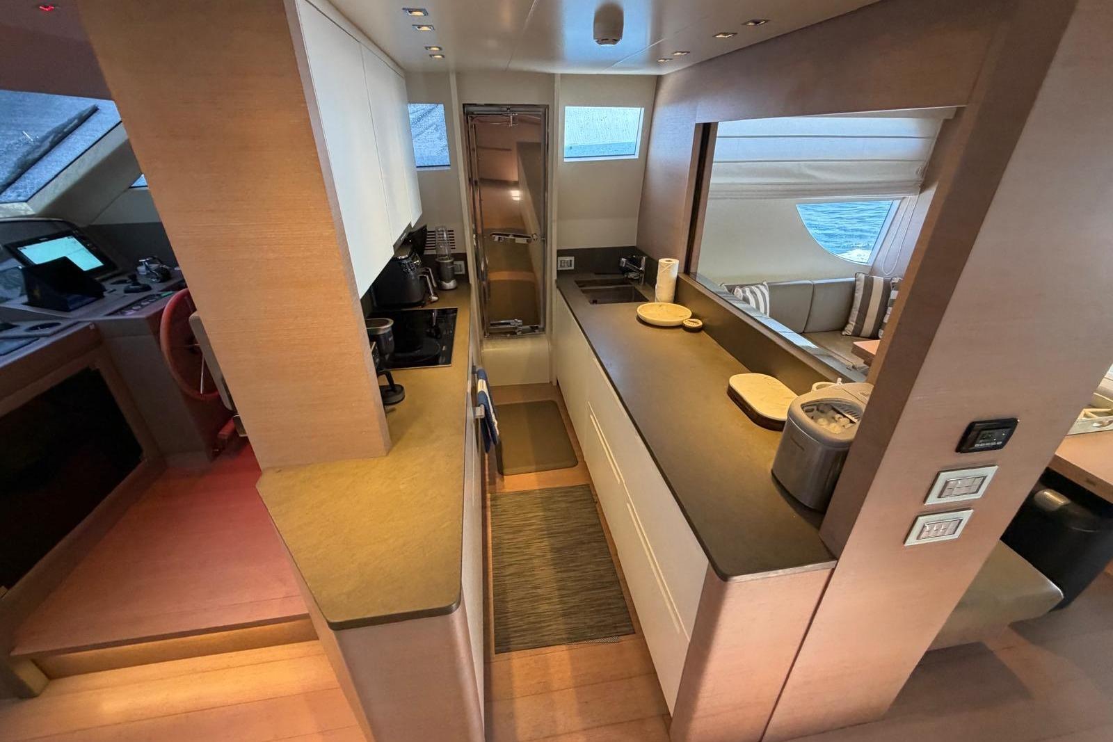 Modern kitchen interior of 2012 Sanlorenzo SL72 yacht, featuring sleek countertops and appliances.