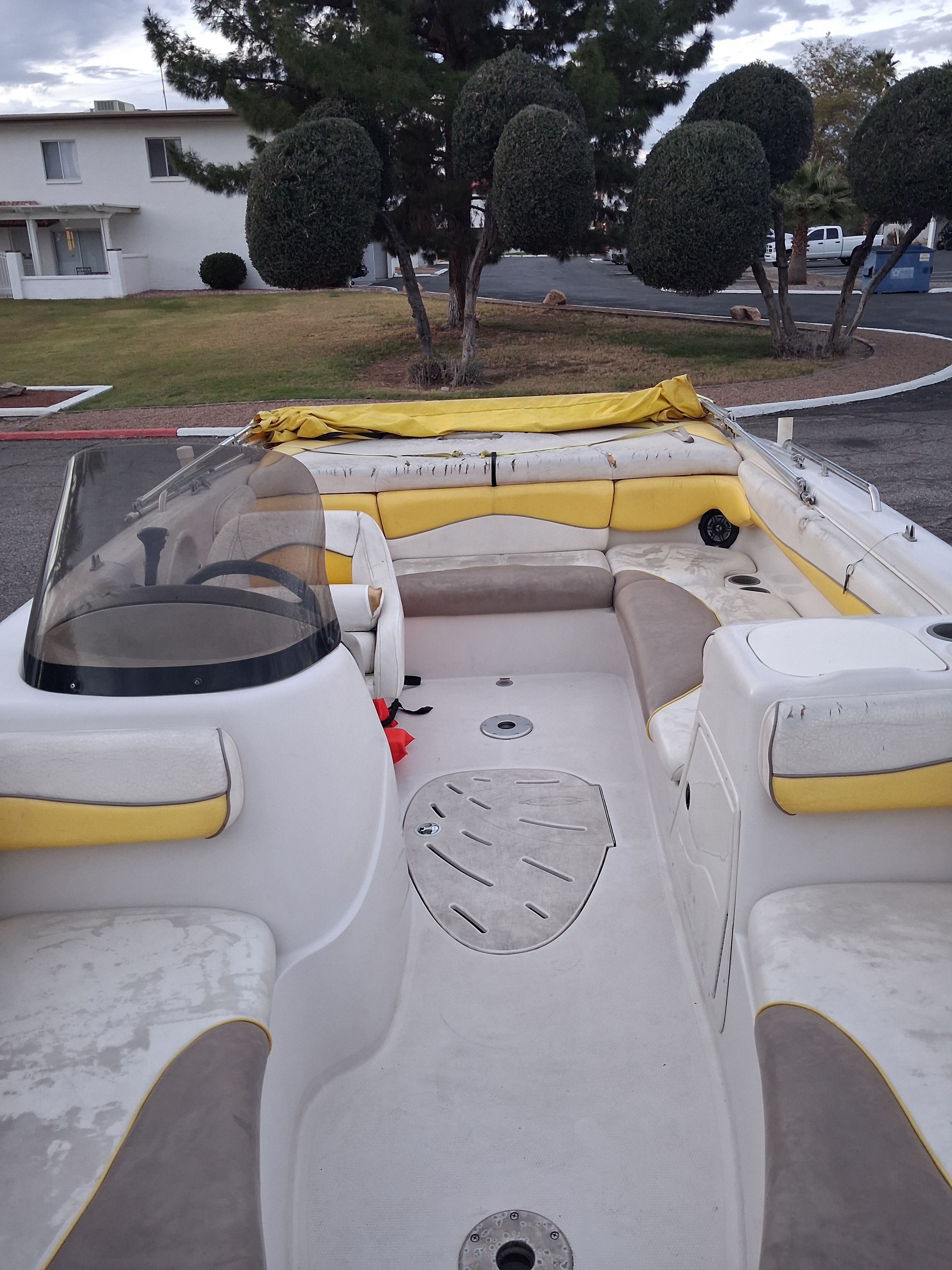 2004 Tracker Tahoe boat with yellow seats and steering wheel.