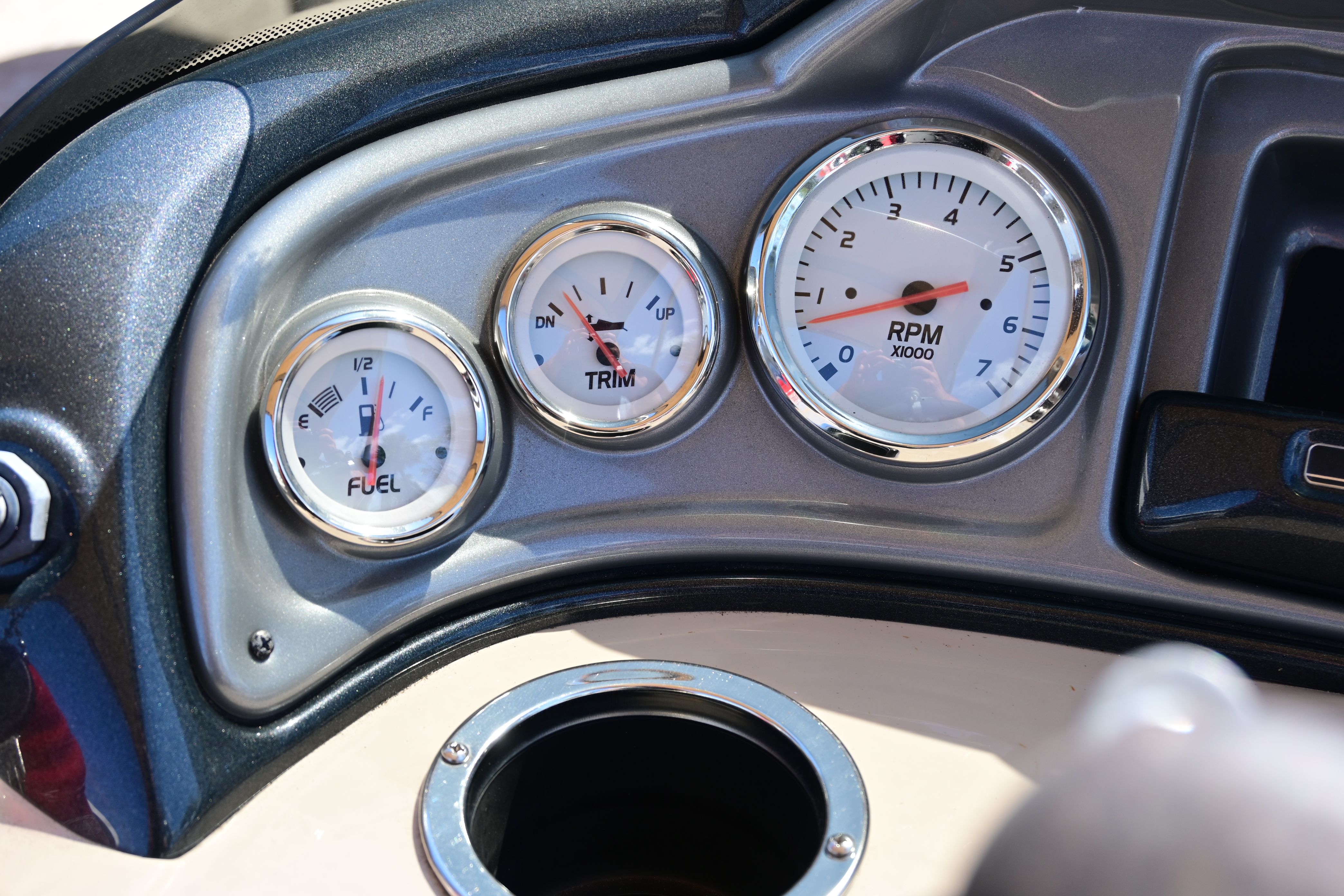 Dashboard of a 2019 Sun Tracker FISHI with fuel and RPM gauges.