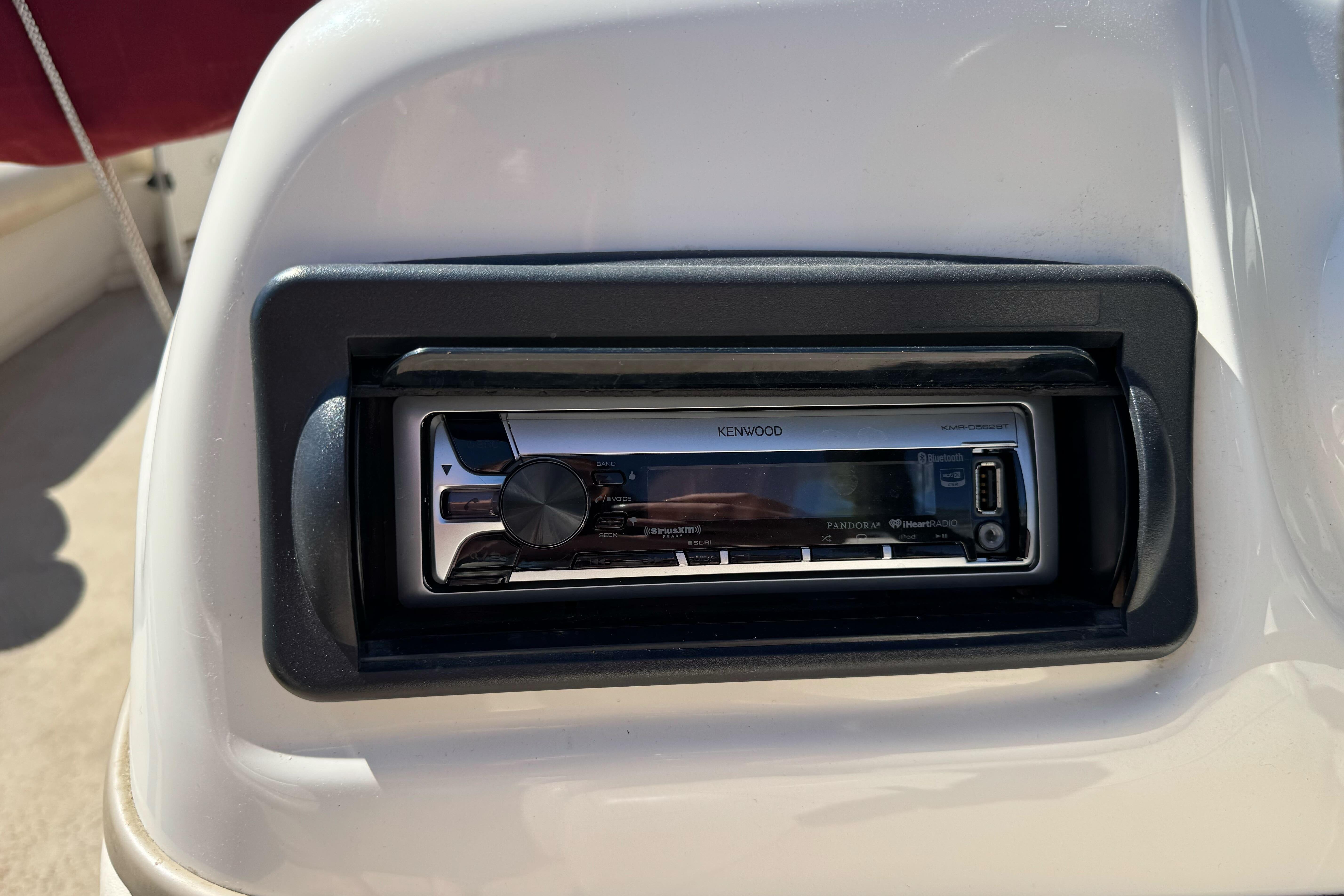 Kenwood stereo system on 2011 Sun Tracker Party Barge 21 boat dashboard.