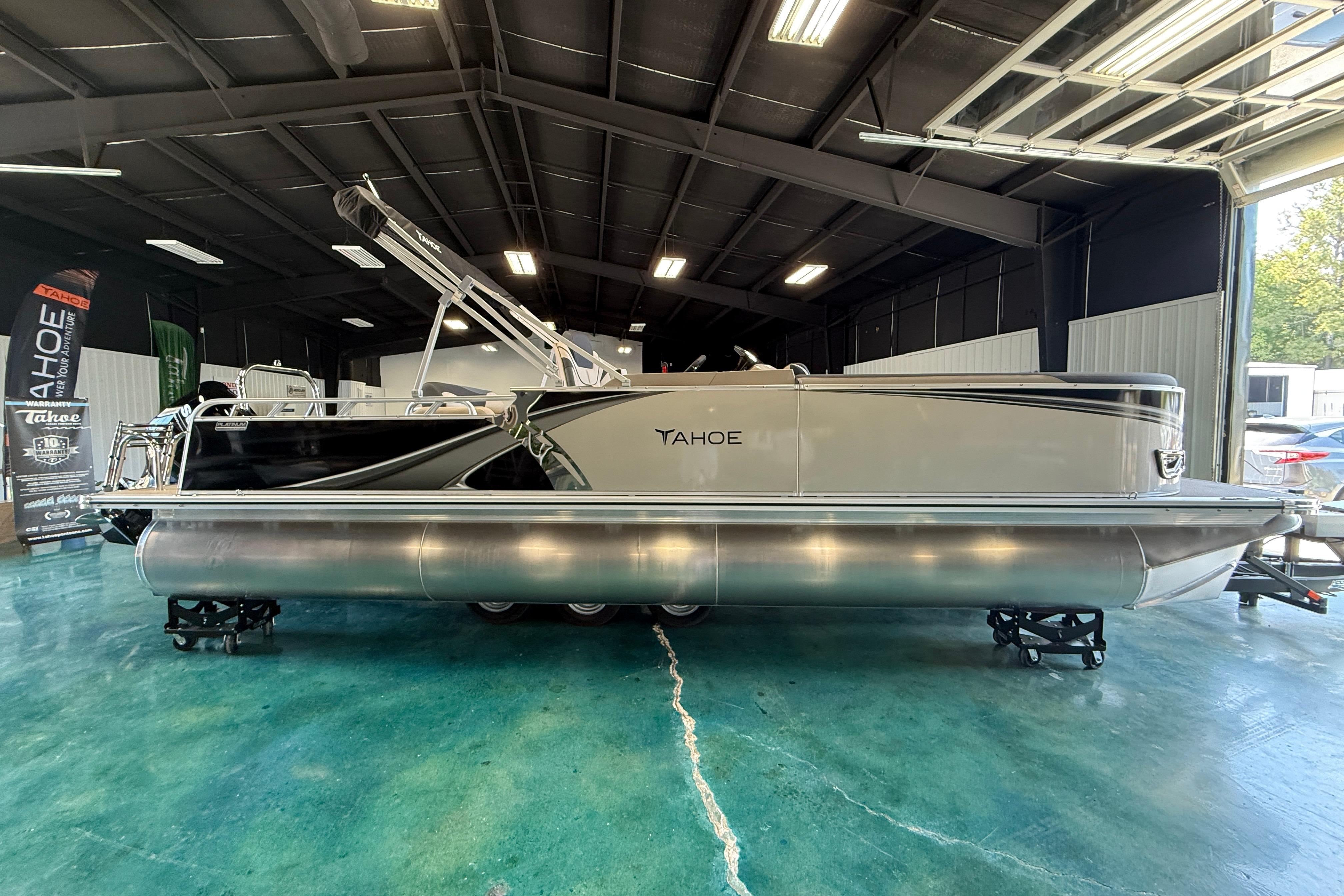 2026 Tahoe Pontoon LTZ Entertainer in showroom, sleek design, metallic finish.