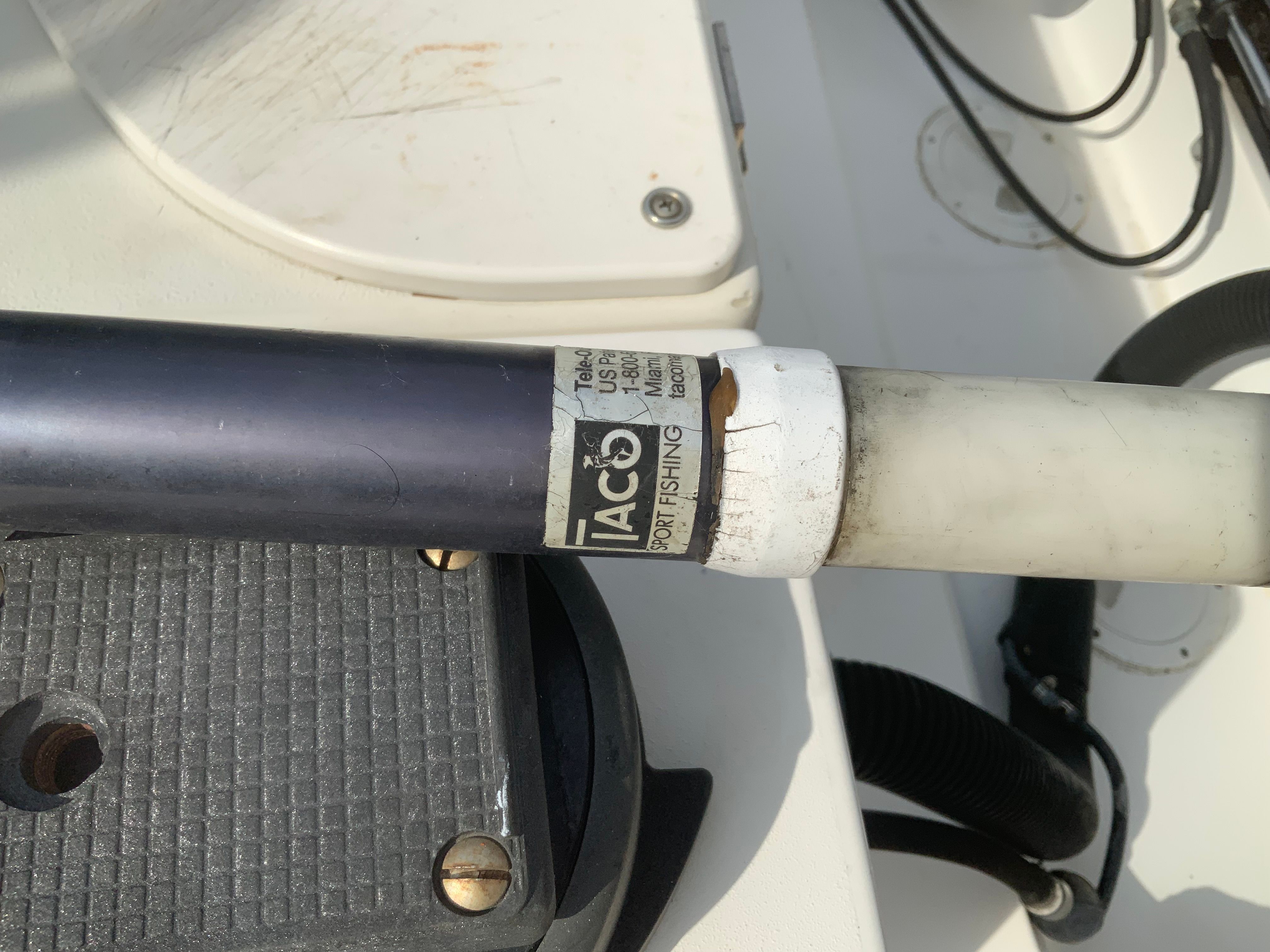 Close-up of a fishing rod holder on a boat.