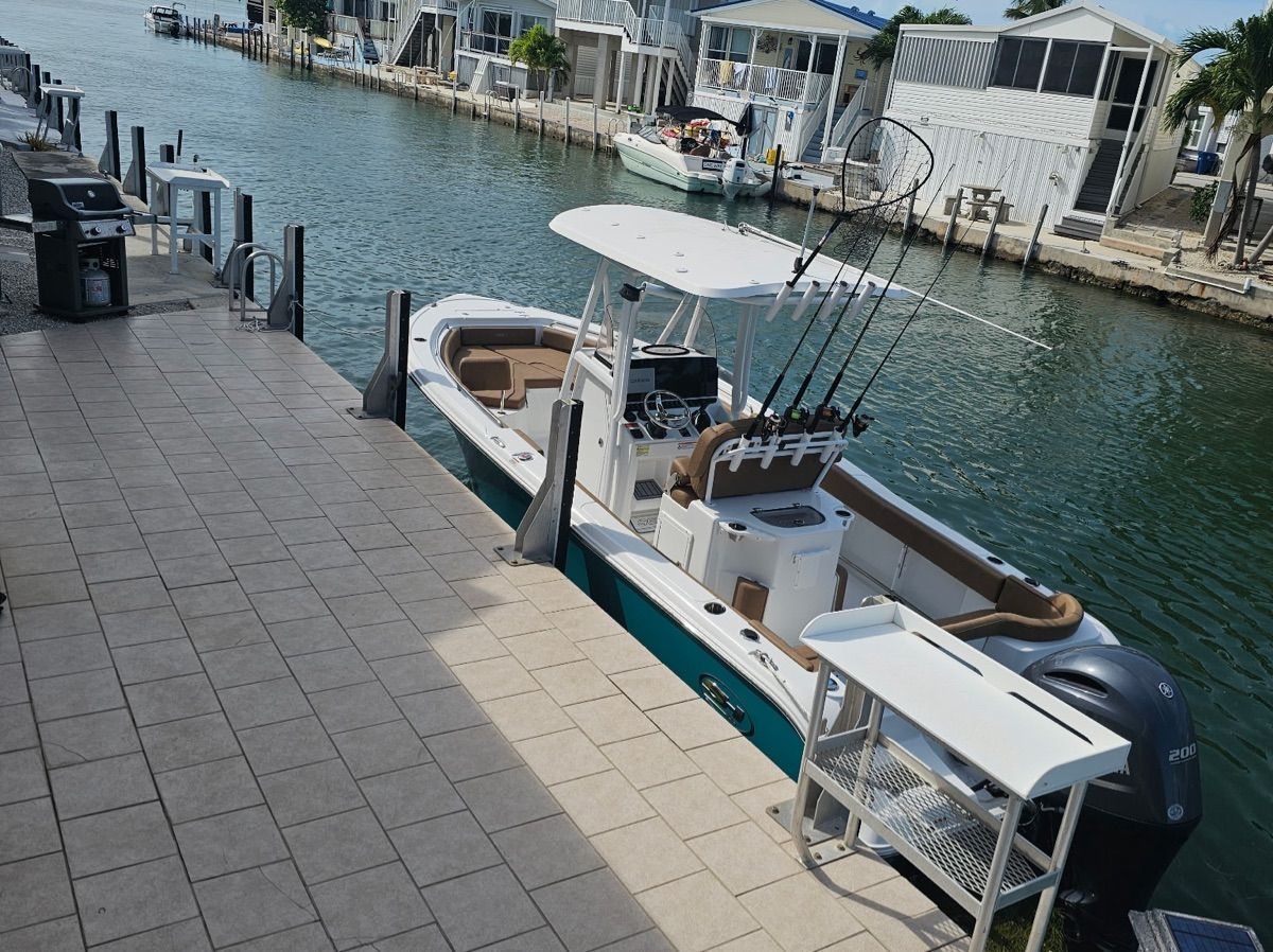 2022 Sea Hunt Ultra 234 boat docked with fishing rods.