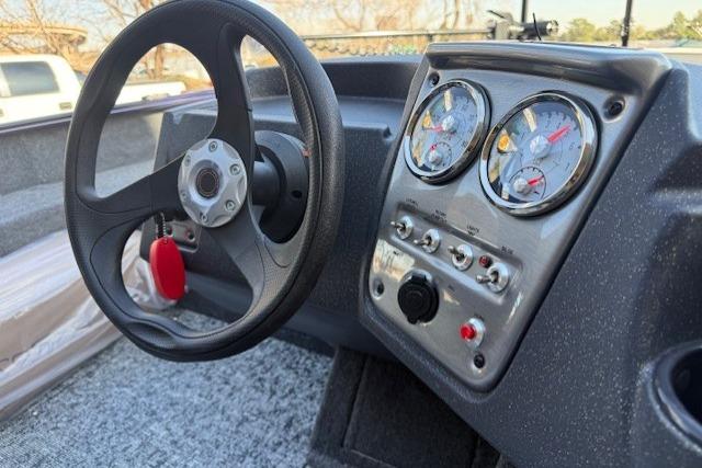 Steering wheel and dashboard of 2026 Tracker Pro Guide V-16 SC boat.