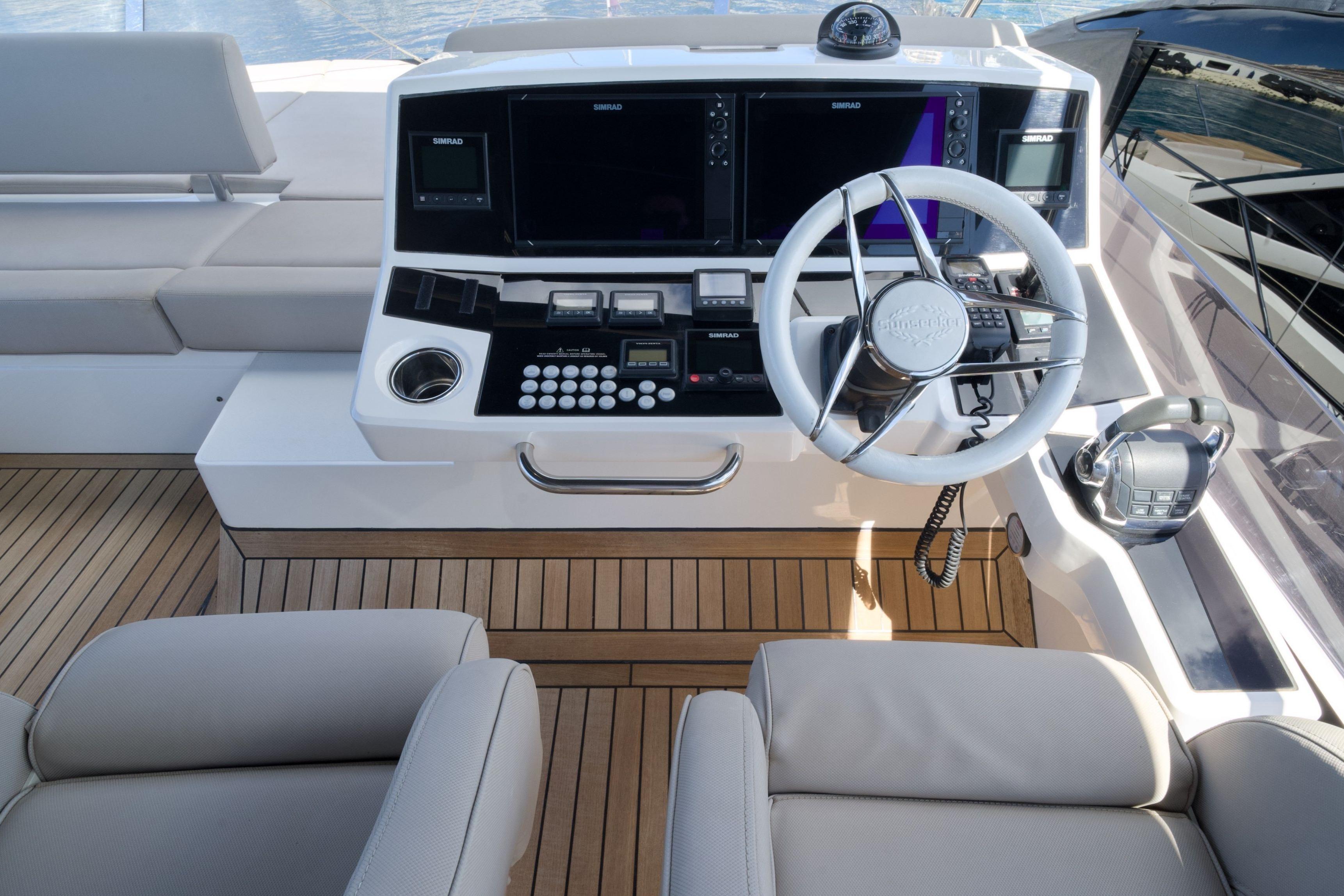 Cockpit of 2019 Sunseeker Manhattan 52 yacht with modern controls and steering wheel.