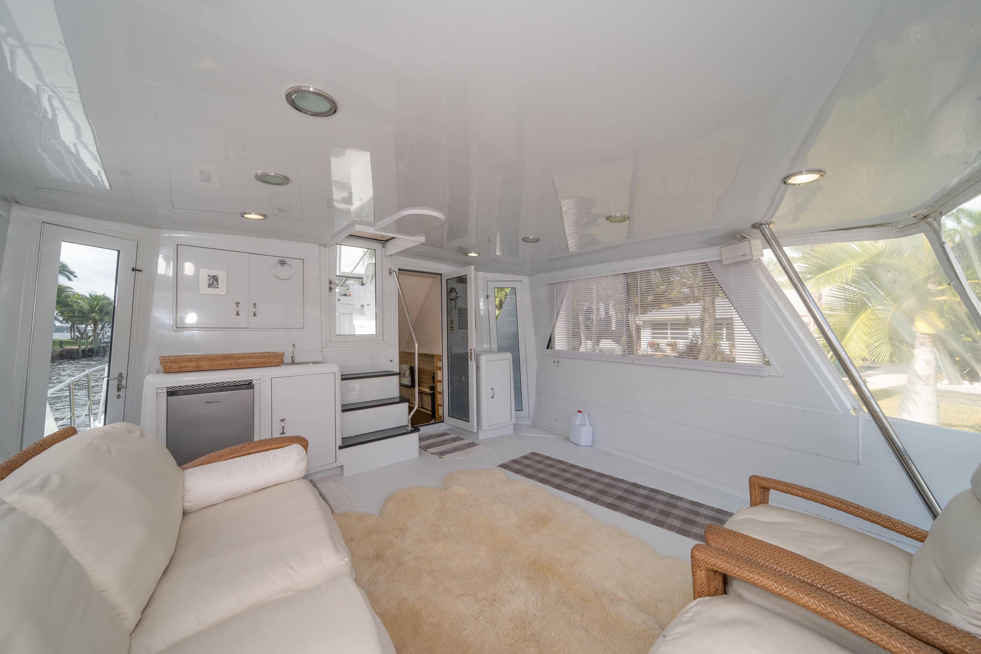 Luxurious interior of 1999 Hatteras 52 Cockpit Motor Yacht with plush seating and modern amenities.
