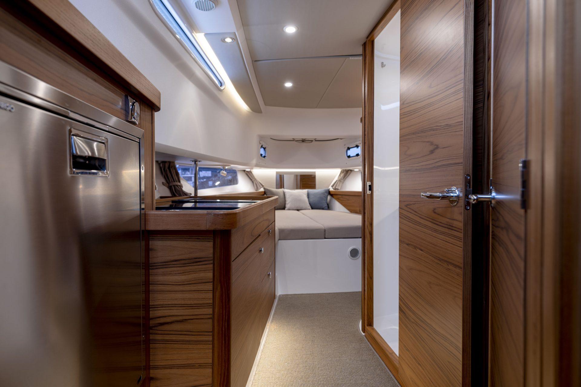 Interior of Nimbus Commuter 11 yacht, 2025 model, featuring wood paneling.