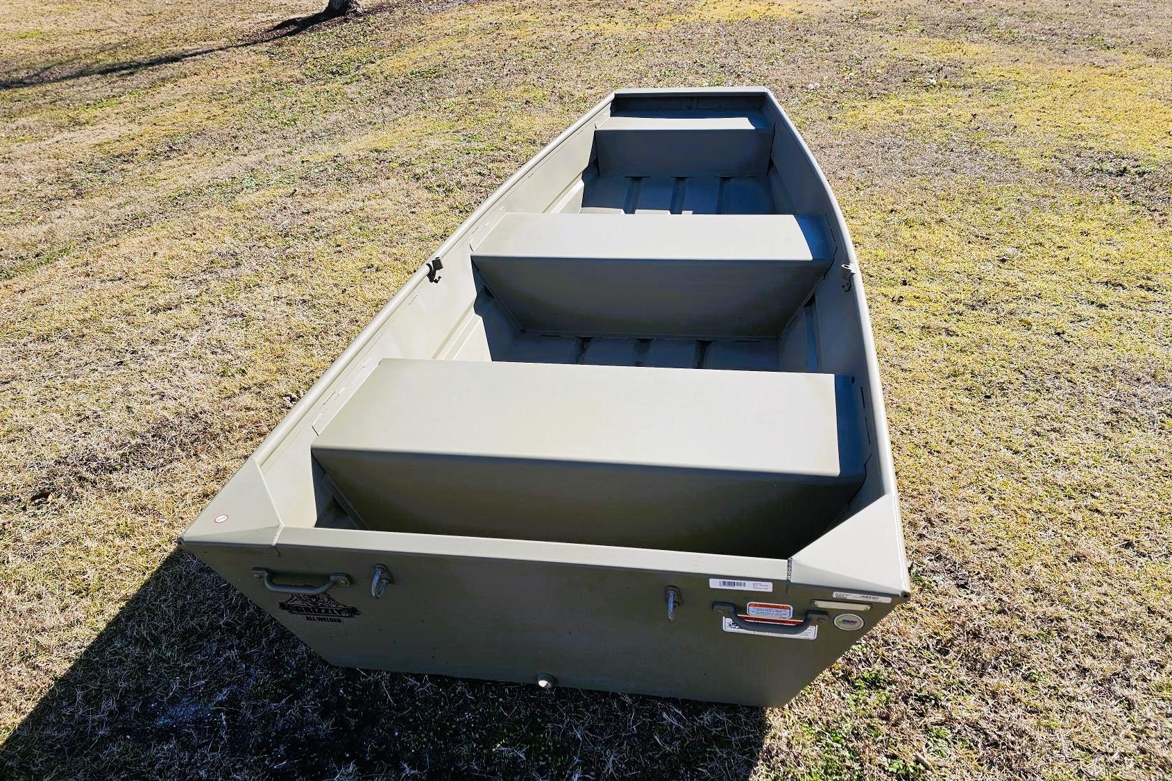 2026 Tracker Grizzly 12 Jon boat on grassy field, showcasing interior seating.