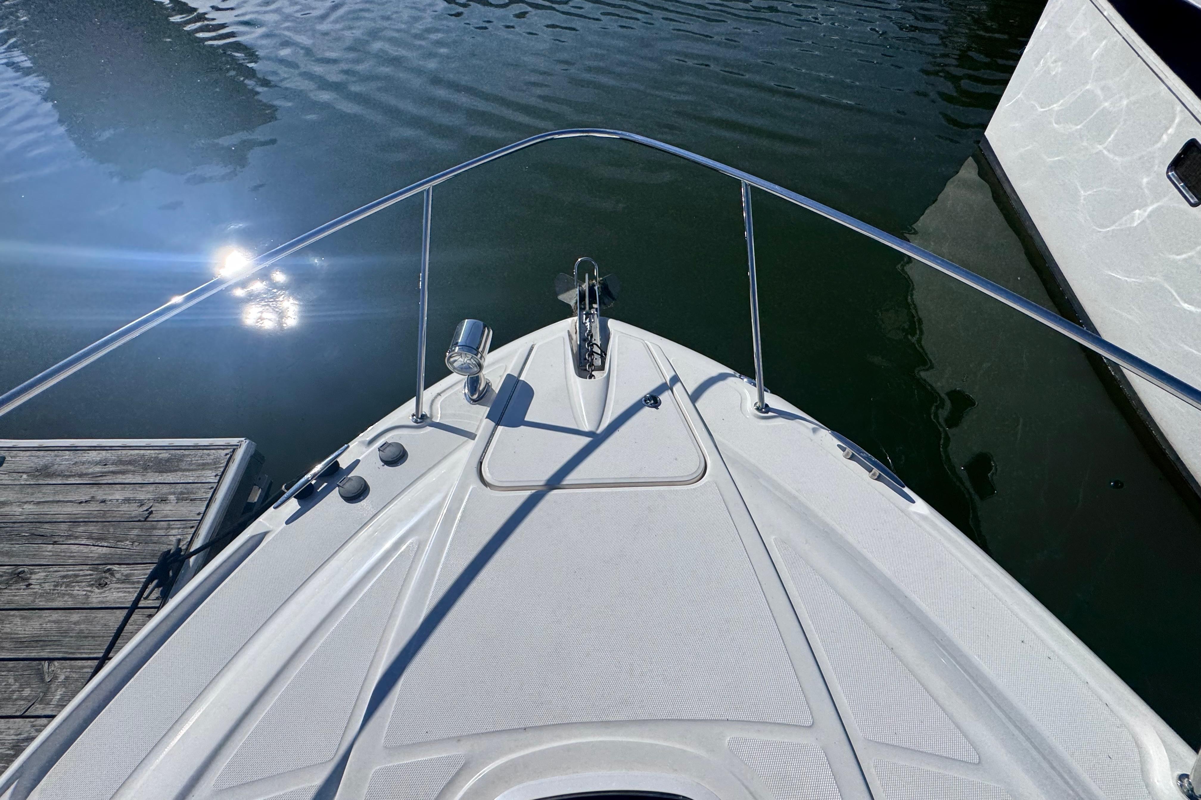Bow view of 2008 Sea Ray 350 Sundancer docked on calm water.