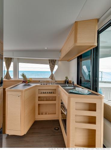 Modern kitchen interior of 2025 Lagoon 42 Millenium yacht with ocean view.