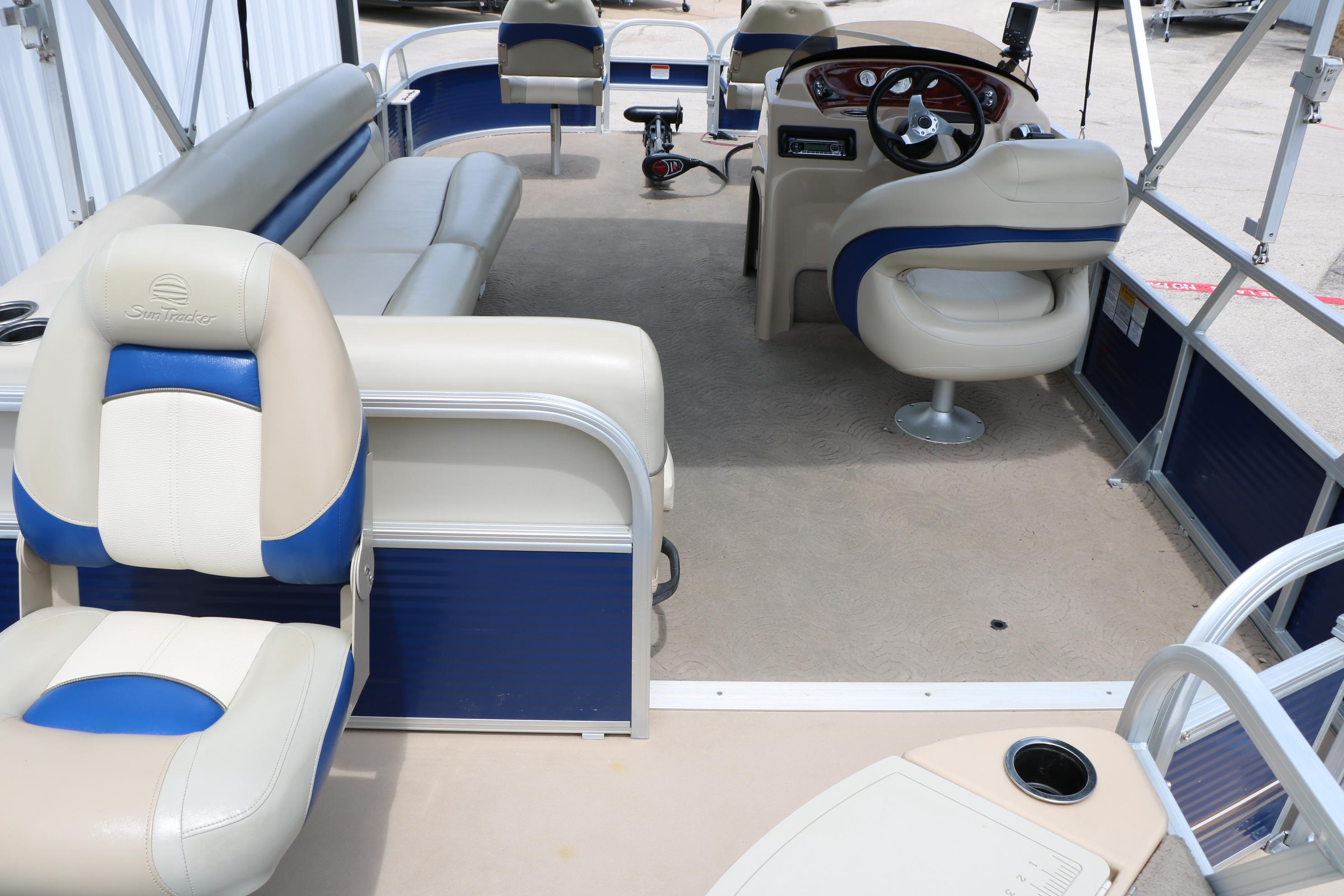 2013 Sun Tracker Fishin' Barge 20 DLX interior with seating and steering console.