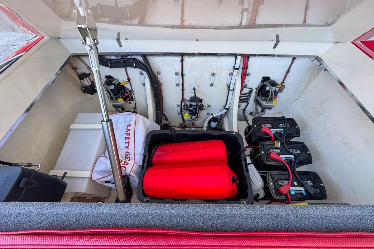 2022 Velocity 290sc boat engine compartment with batteries and safety gear.